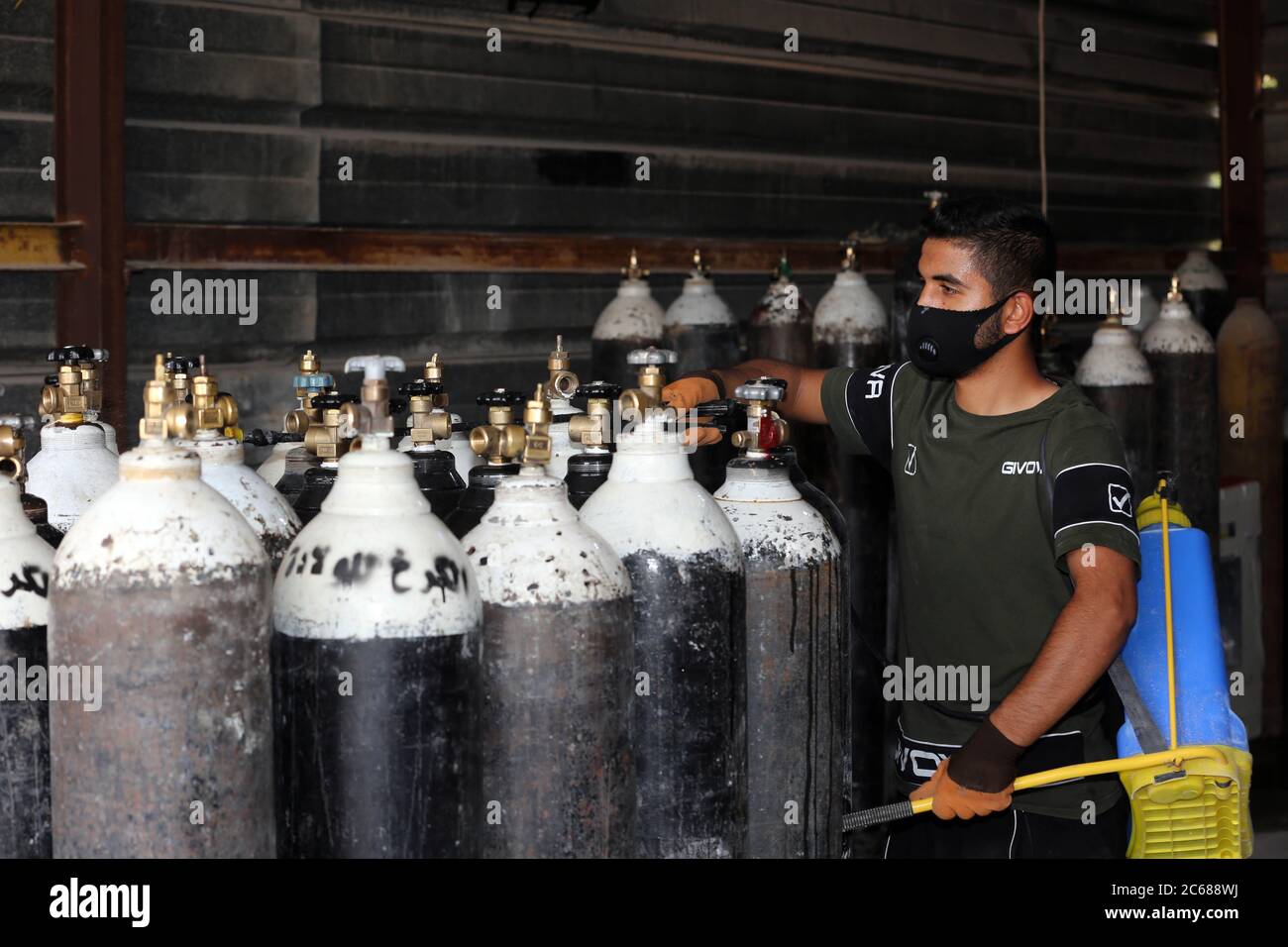 Baghdad. 7th July, 2020. A man works at an oxygen refilling station in Baghdad, Iraq, on July 7, 2020. A government-owned oxygen filling factory in Iraq has increased its filling of oxygen cylinders and the liquid gas to meet the demand of the Iraqi hospitals amid the continued rise in COVID-19 infections. The resurgence of COVID-19 pandemic continued in Iraq on Tuesday, as the Iraqi Health Ministry confirmed 2,426 new cases, bringing the total number of coronavirus infections nationwide to 64,701. Credit: Xinhua/Alamy Live News Stock Photo
