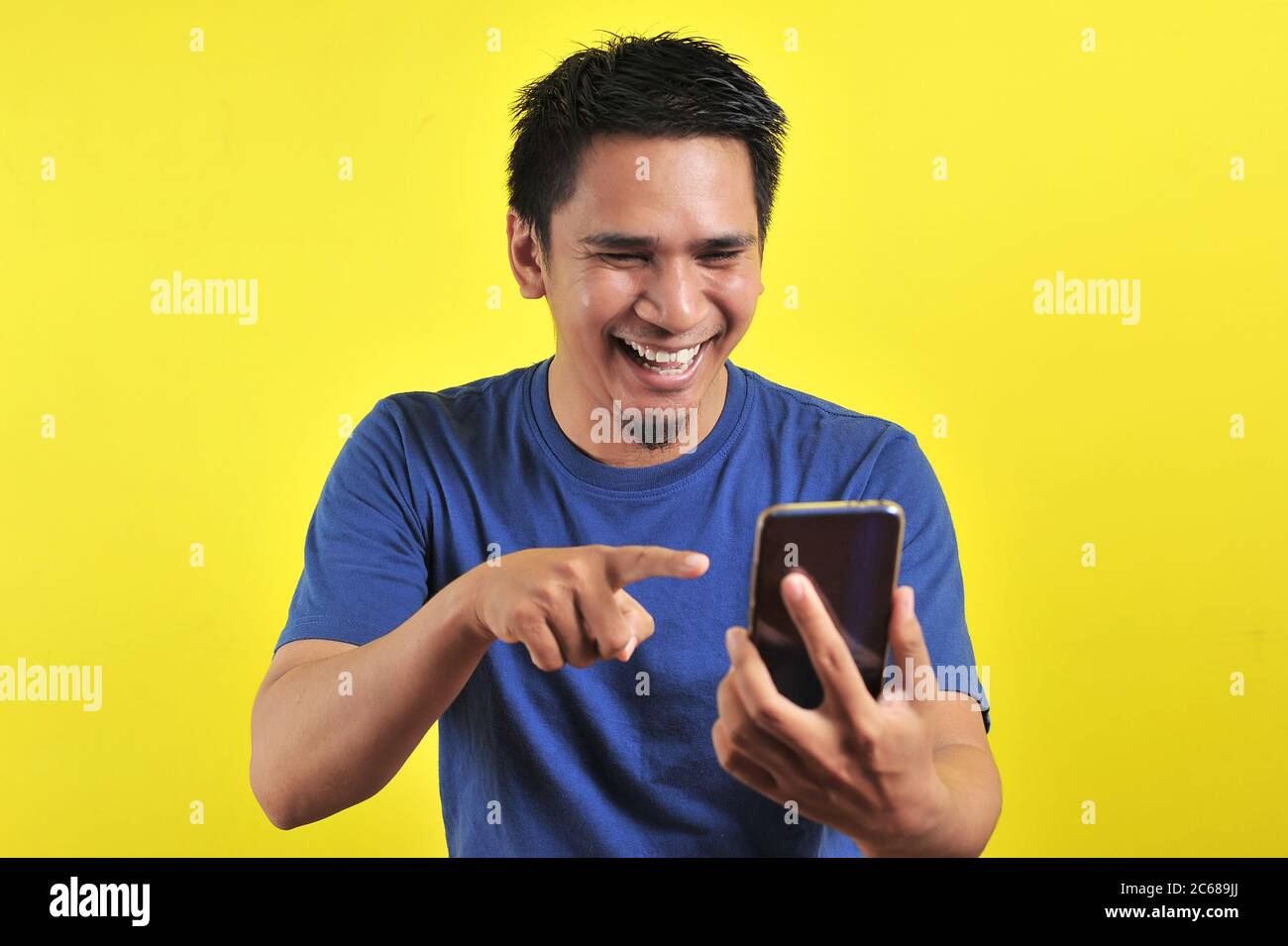 Happy of young good looking Asian man smiling using smartphone isolated ...