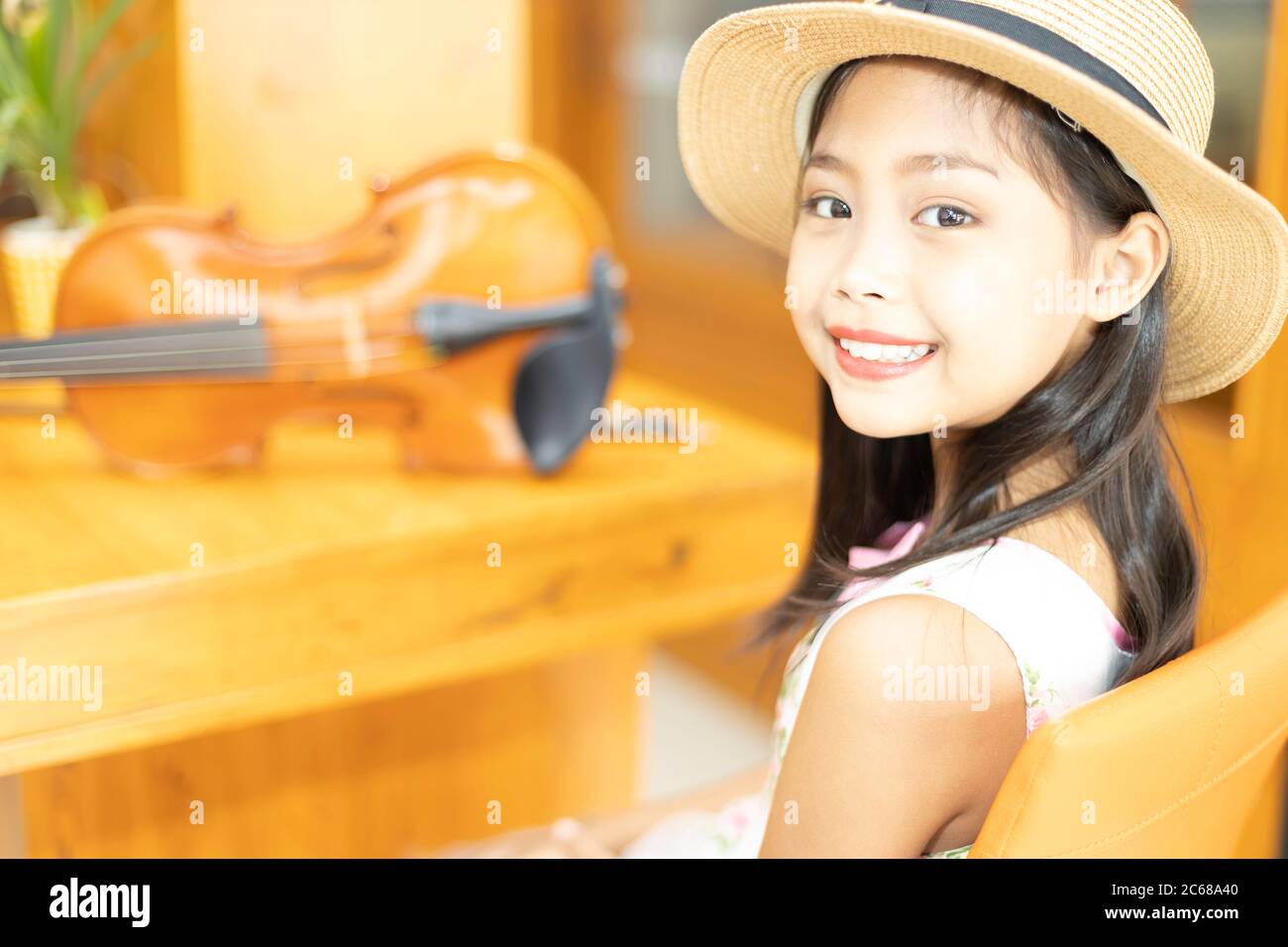 Portrait of a cute Asian elementary school girl with her violin Stock Photo