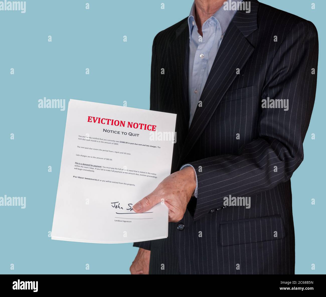 Man in suit serving an eviction notice to a defaulting renter in due to missed rent in recession Stock Photo