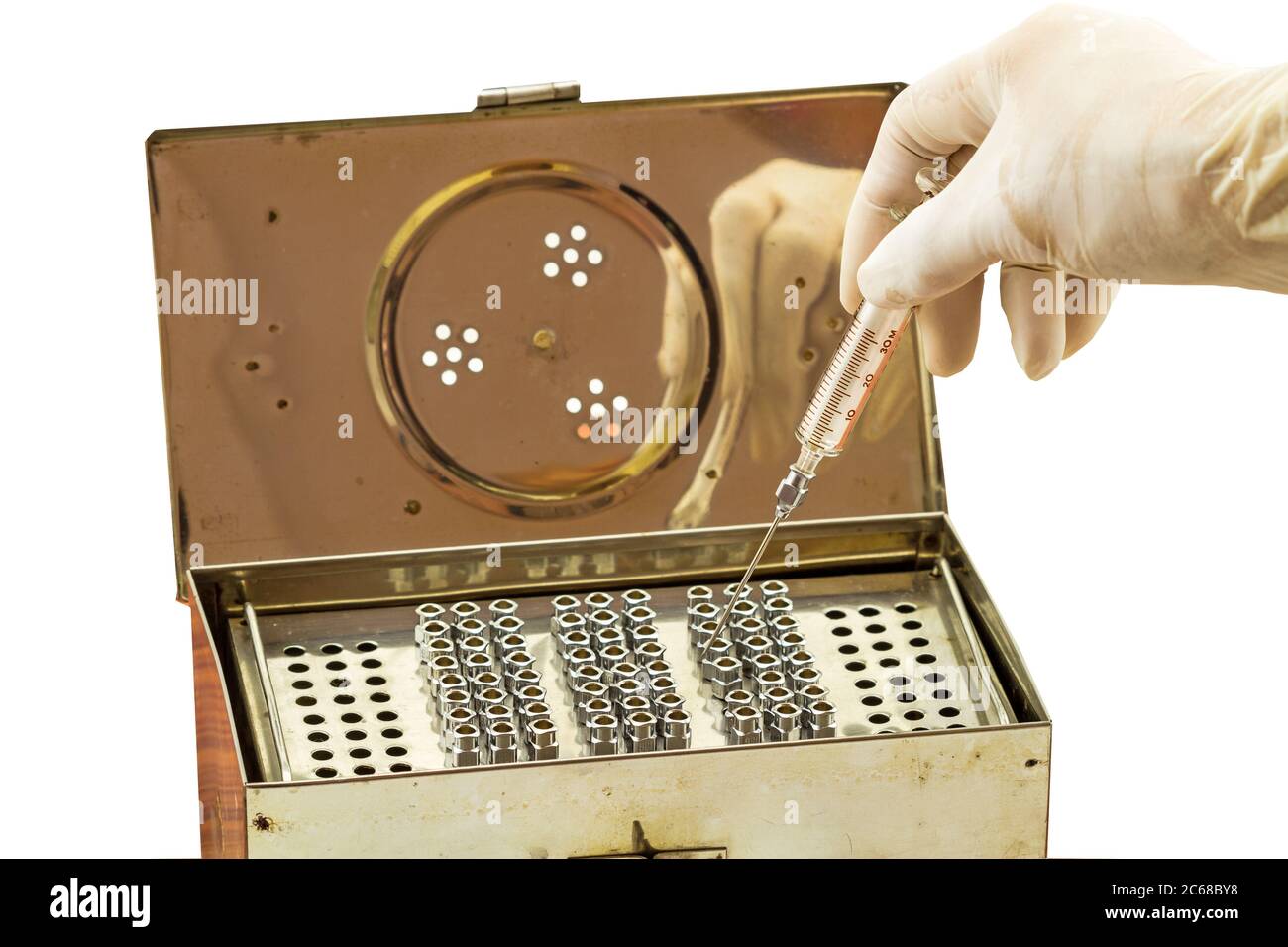 Doctor put glass syringe in stainless box of Stack of reuse iron needle