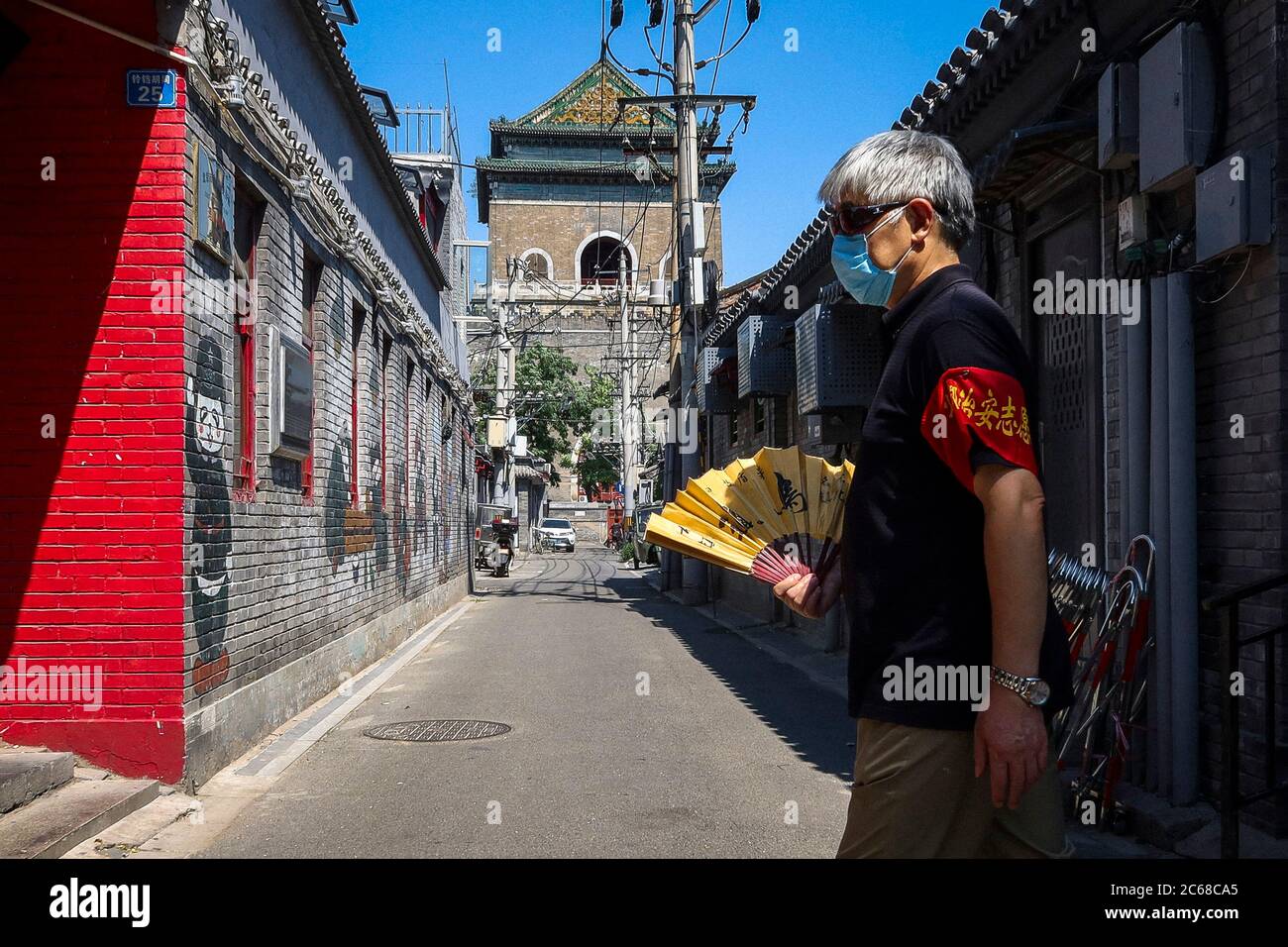 Beijing, China. 07th July, 2020. A man with a fan walking down the street at usually busy touristic area of Bell Tower in Beijing, China on 07/07/2020 The Chinese capital took strict measures to stop the spread of Covid-19 as new cases of coronavirus disease (COVID-19) were reported in June. by Wiktor Dabkowski | usage worldwide Credit: dpa/Alamy Live News Stock Photo