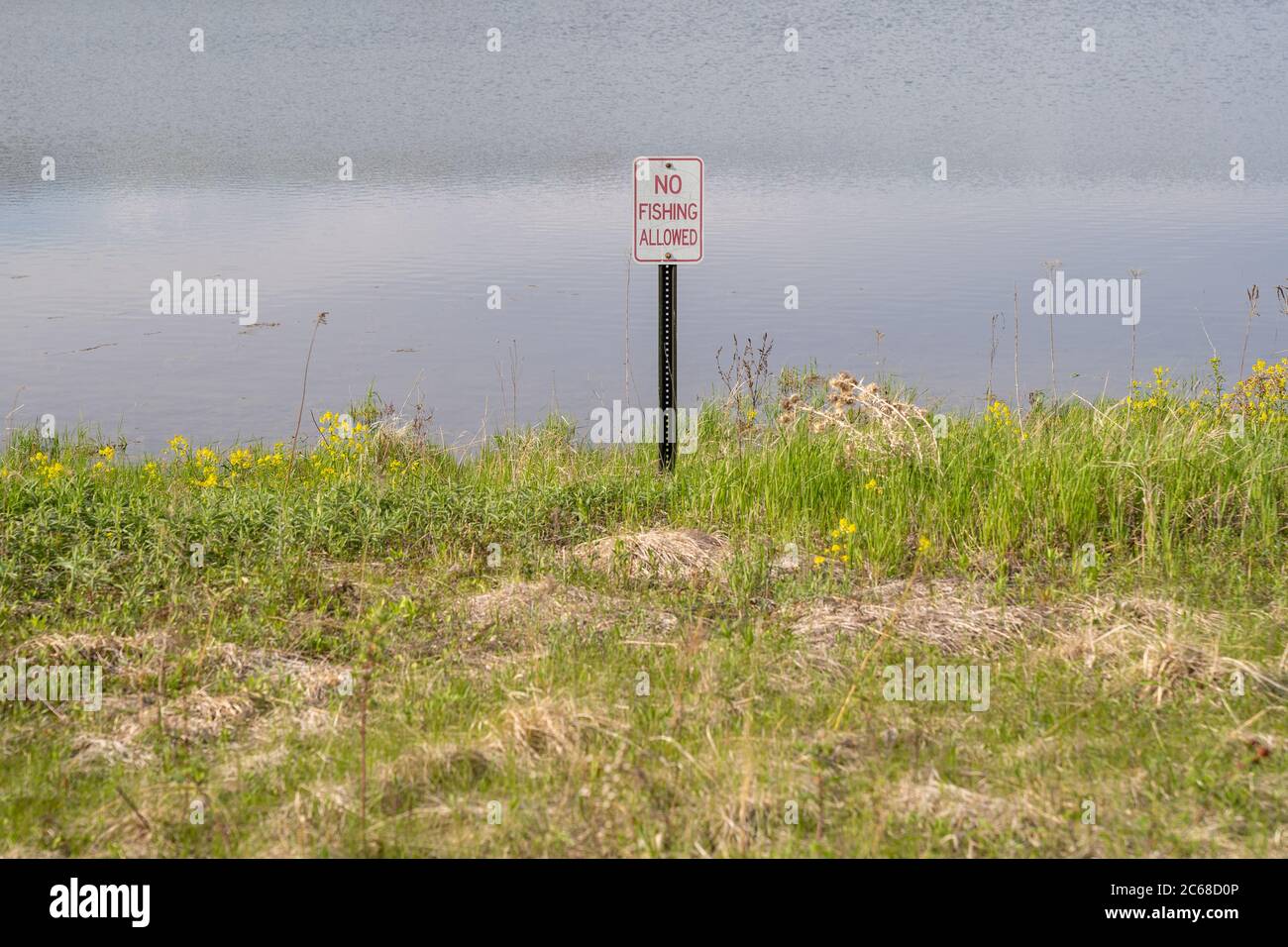 No fishing allowed sign near a lake. Taken in the Arbor Lakes area of Maple Grove, Minnesota Stock Photo
