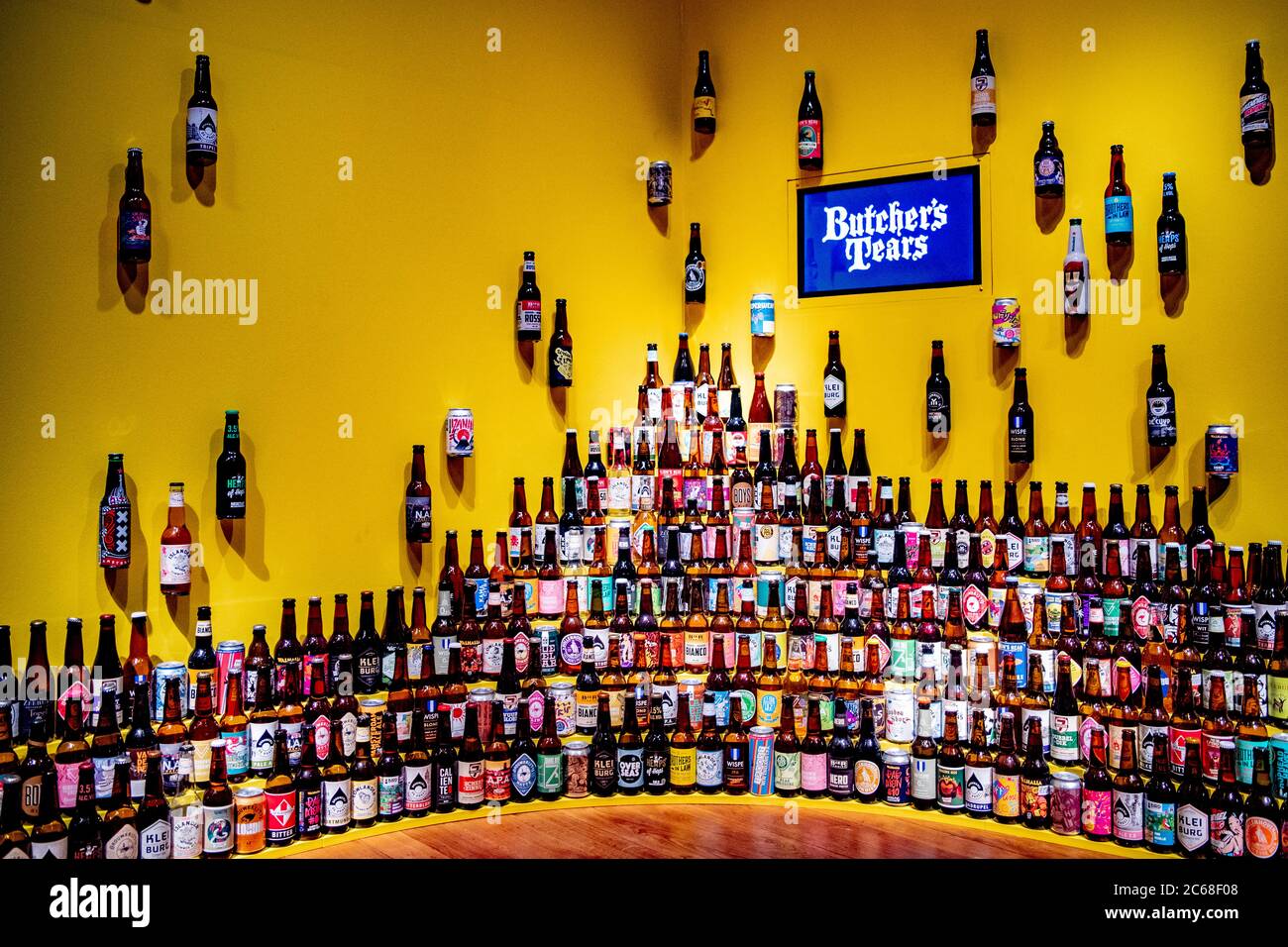 A wall decorated with beer bottles during the beer exhibition.Amsterdam Museum presents the exhibition Beer.  Amsterdam is known as the city of beer and brewers. In the exhibition Beer, visitors can learn all about the capital's beer history. Many Amsterdam mayors were brewers, breweries such as Heineken once started there and today the city has no less than 45 beer breweries. Stock Photo