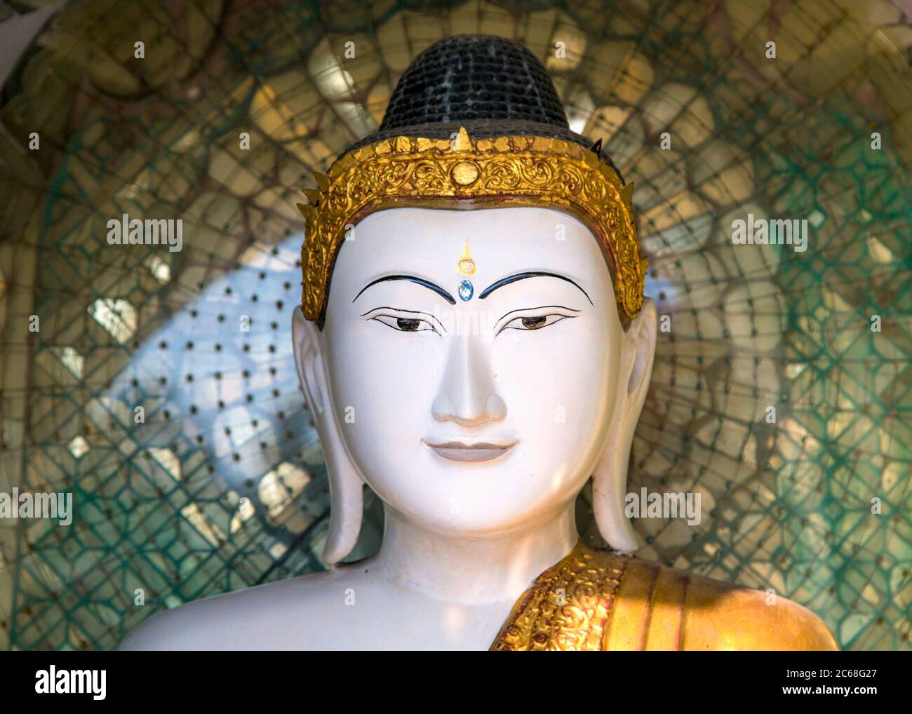 Close-up view of the face of a Buddha Statue in the Shwedagon Pagoda, Yangon, Myanmar Stock Photo