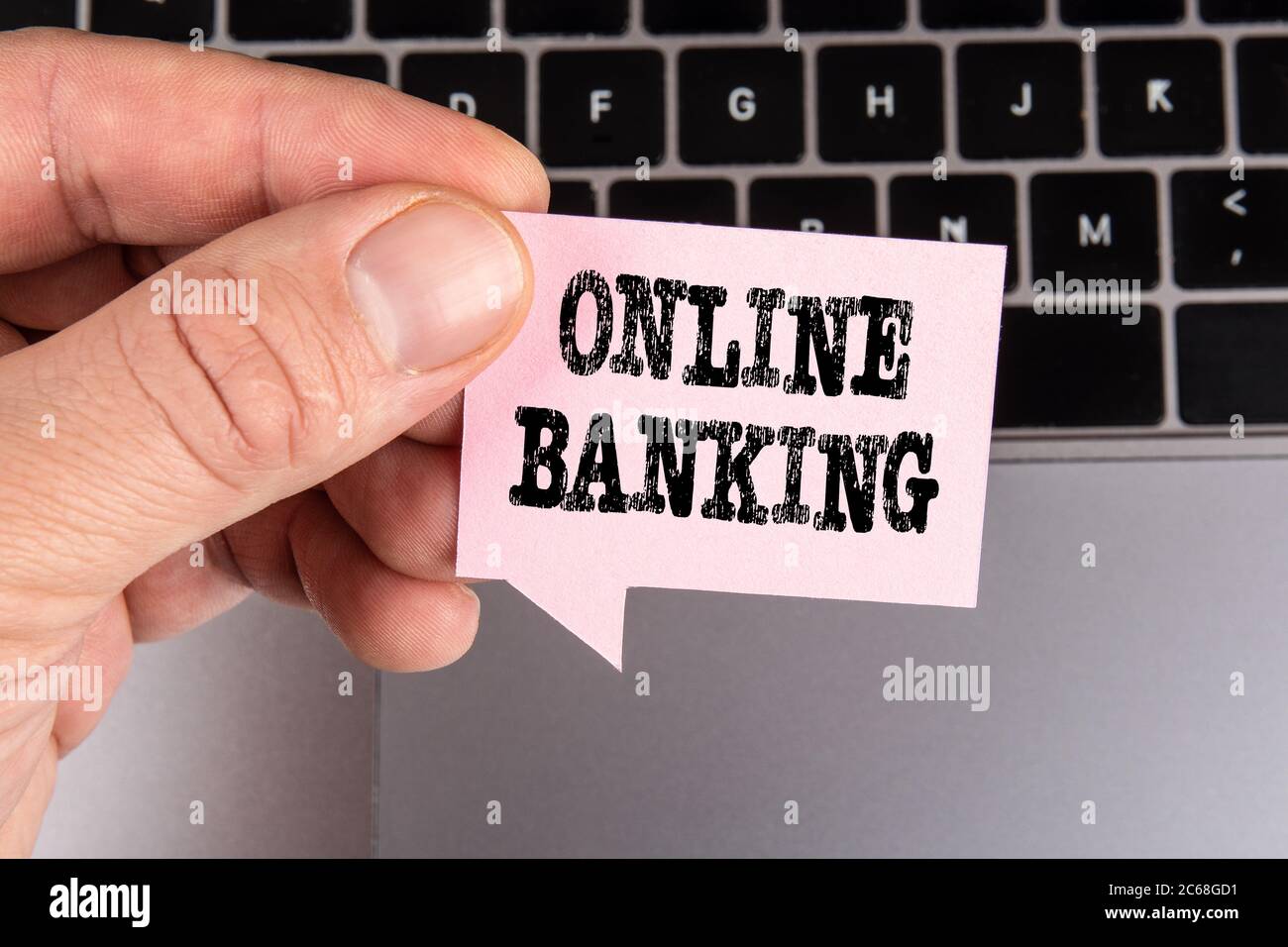 ONLINE BANKING. Financial services, transfers, insurance and loans concept. Gray laptop and pink speech bubble Stock Photo