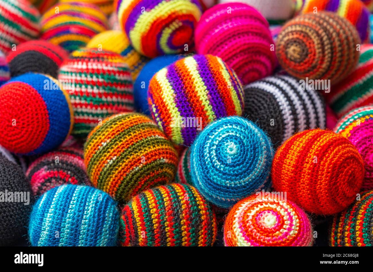 Colorful fabric textile wool balls on the Andes craft market of Otavalo, north of Quito, Ecuador. Stock Photo