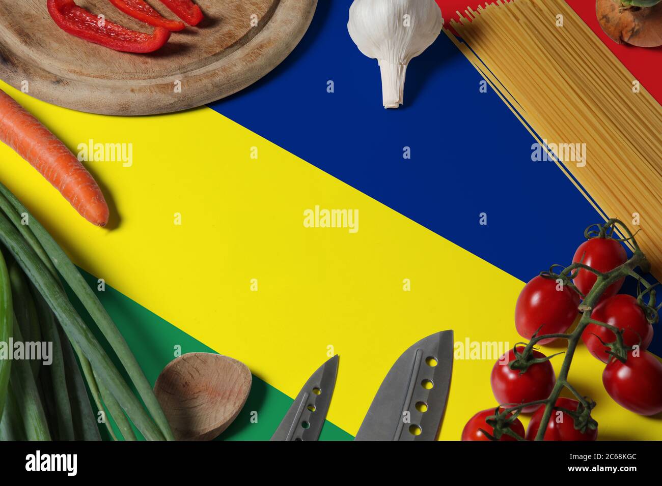 Mauritius flag on fresh vegetables and knife concept wooden table. Cooking concept with preparing background theme. Stock Photo