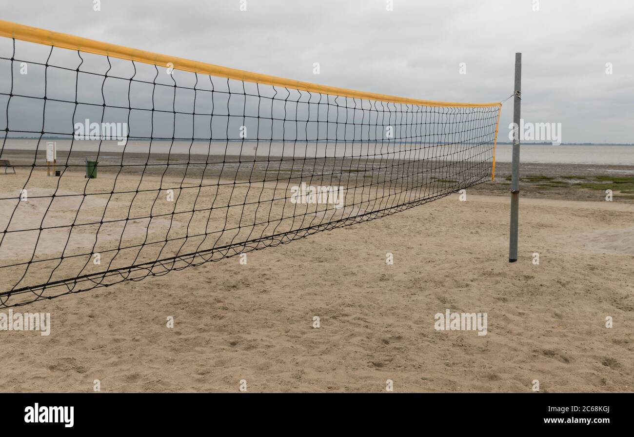 black volleyball net on a beach with north sea in the background Stock Photo