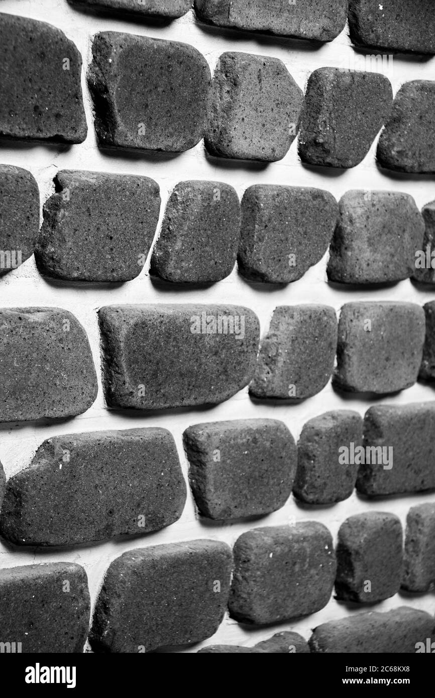 Irregular brick arrangement. On the wall. In black and white. Stock Photo