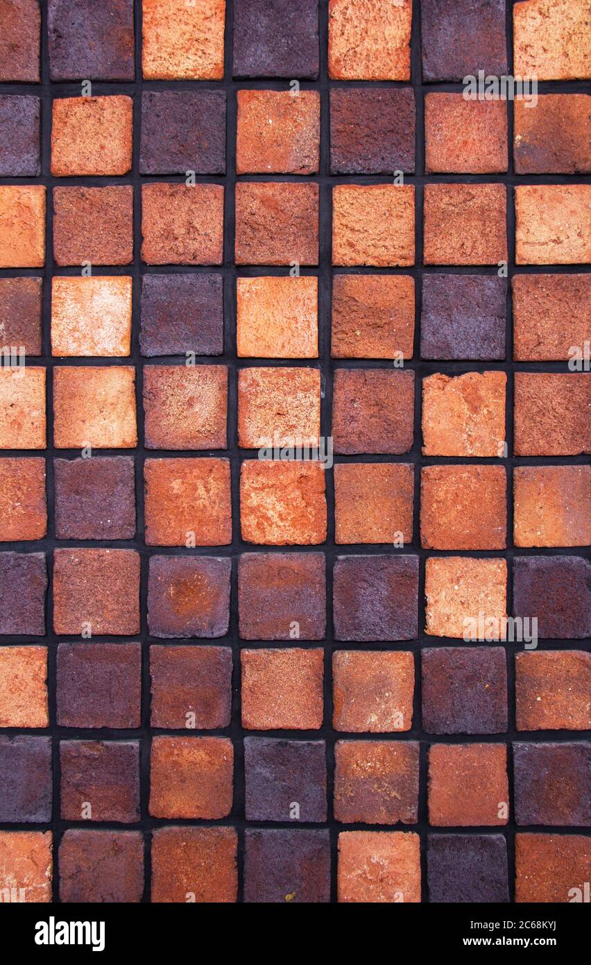 Square layout of bricks side by side on a wall. The front of the
