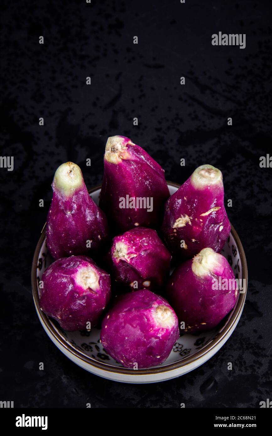 A basket full of peeled purple ripe Barbary figs. Barbary figs are a kind of cactus fruits. Stock Photo