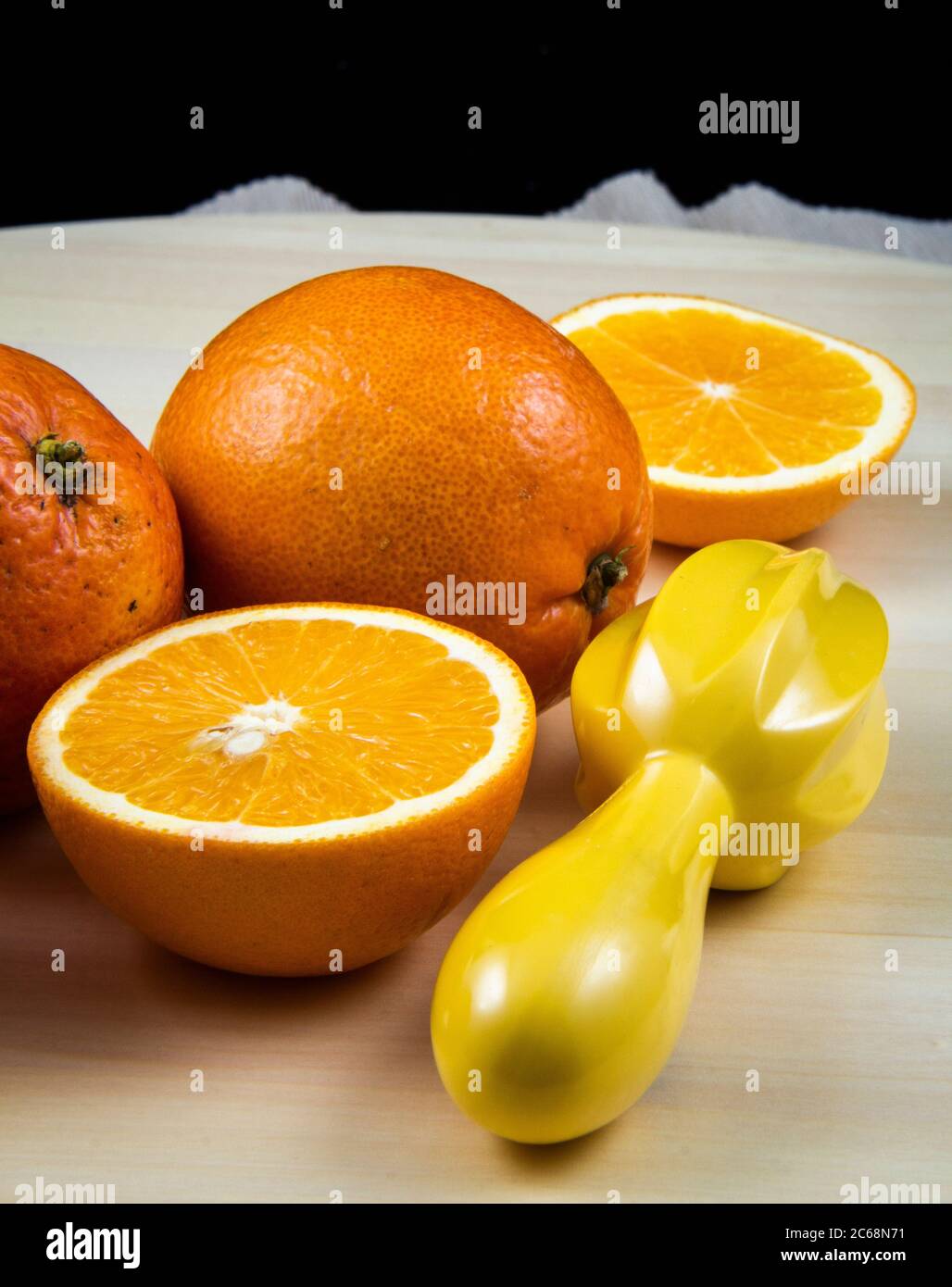 Oranges and chopped oranges with a black background. Orange juice and orange juice extract Stock