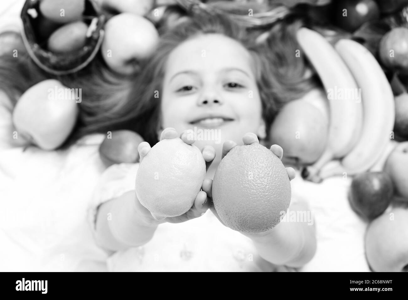 Cute little girl eating banana Black and White Stock Photos & Images
