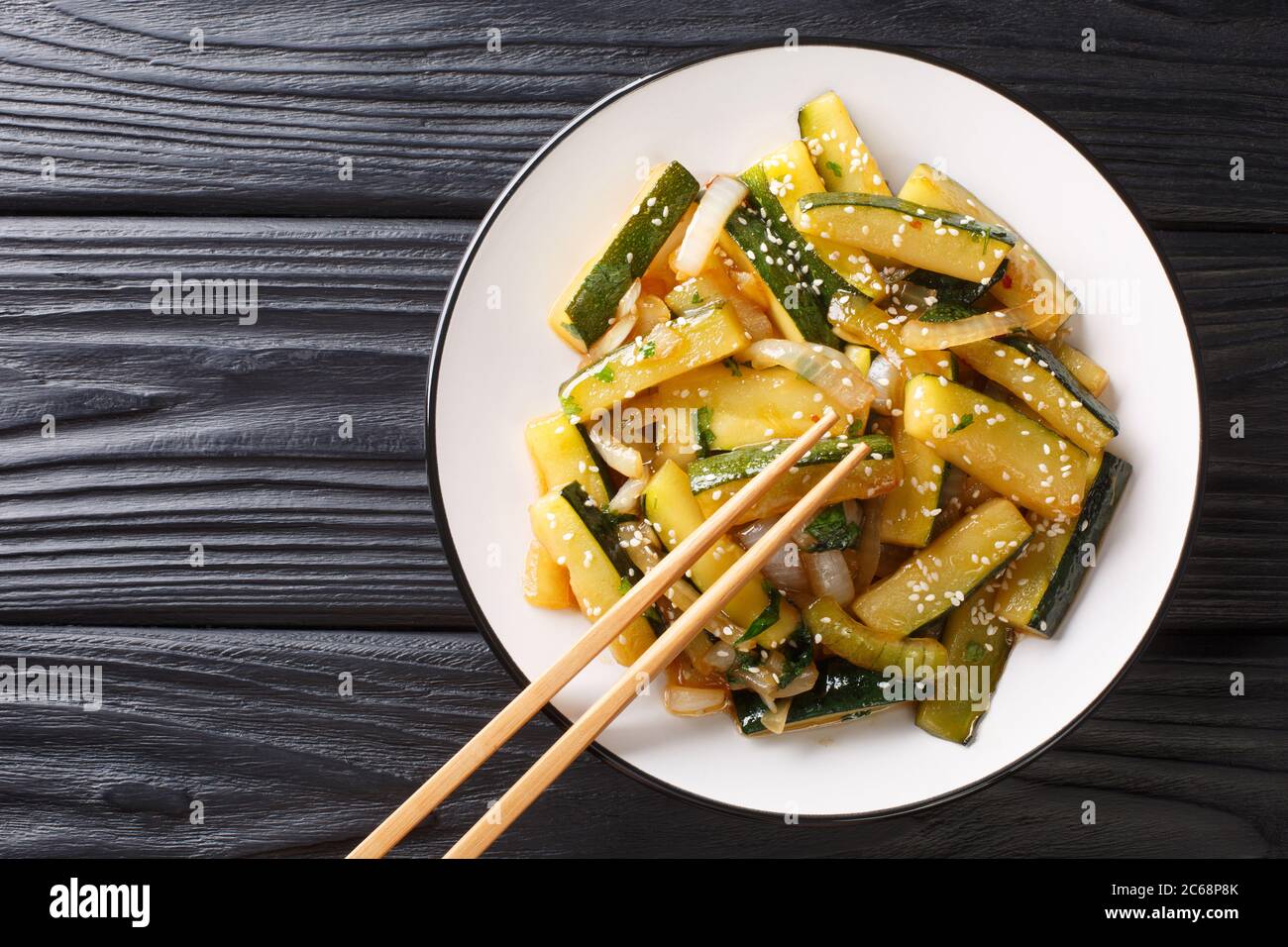 Stir Fried Zucchini With Onions Parsley And Sesame Seeds In Soy Sauce Close Up In A Plate On The Table Horizontal Top View From Above Stock Photo Alamy
