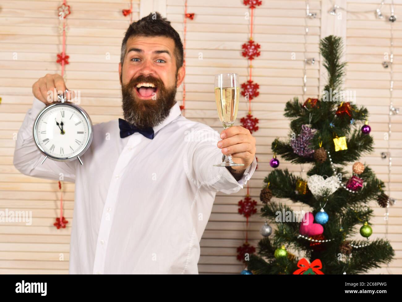 Celebration And New Year Time Concept Guy Near Christmas Tree On Wooden Wall Background Man With