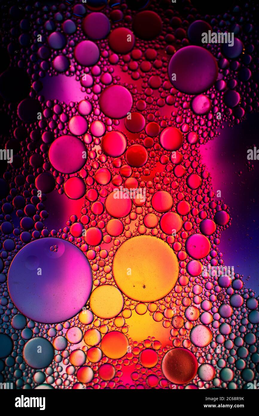 Oil bubbles in water. Yellow, red and purple colors Stock Photo Alamy