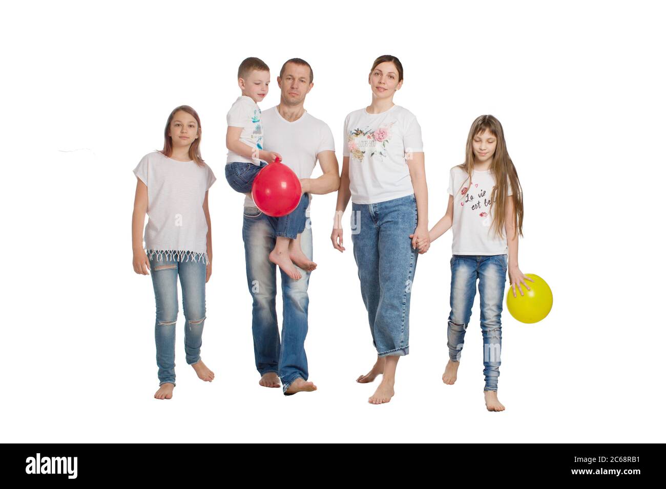 family mom, dad, daughter and son, in casual clothing, isolated on a white background Stock Photo