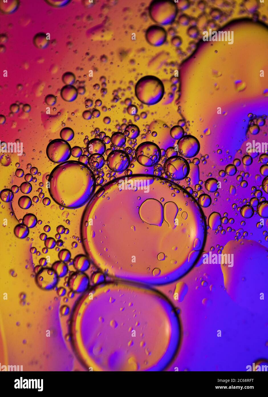 Oil bubbles in water. Orange, yellow and purple colors Stock Photo Alamy