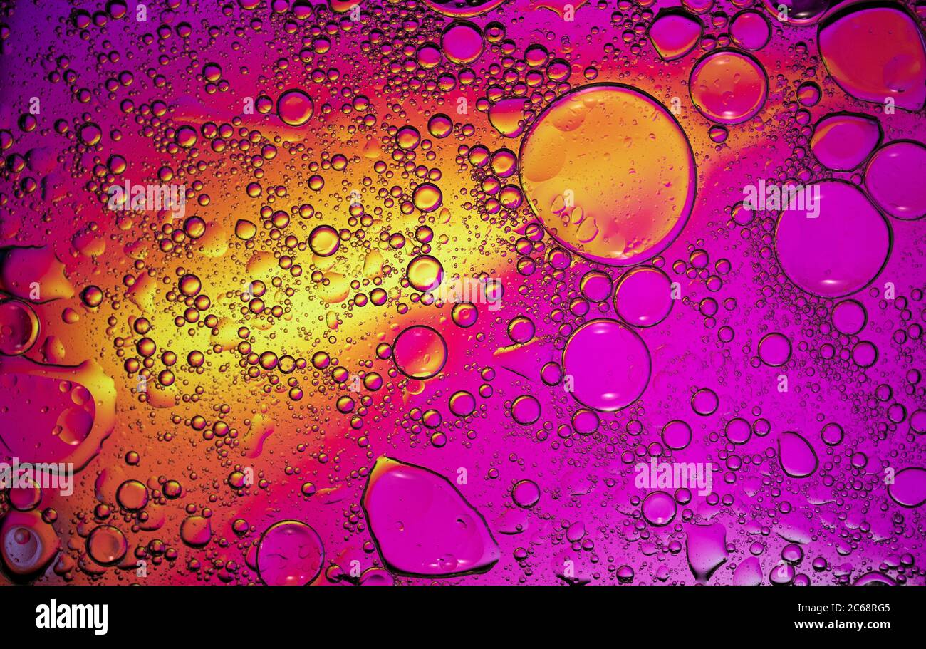Oil bubbles in water. Orange, yellow and purple colors Stock Photo Alamy