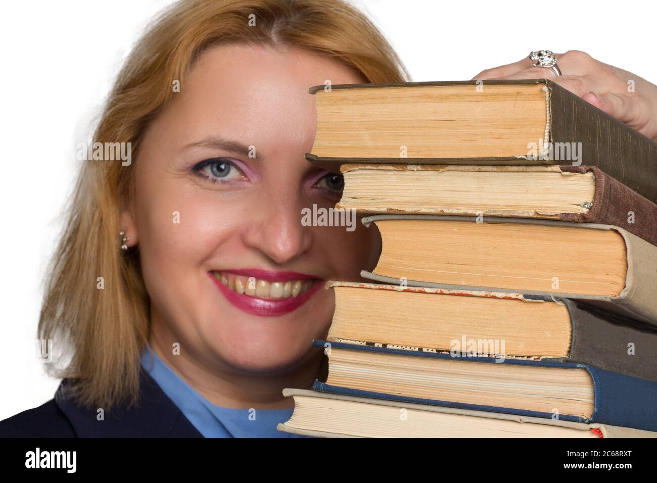 plus size caucasian business office woman. isolated in white. looks out from behind a stack of books. The concept of adult learning Stock Photo