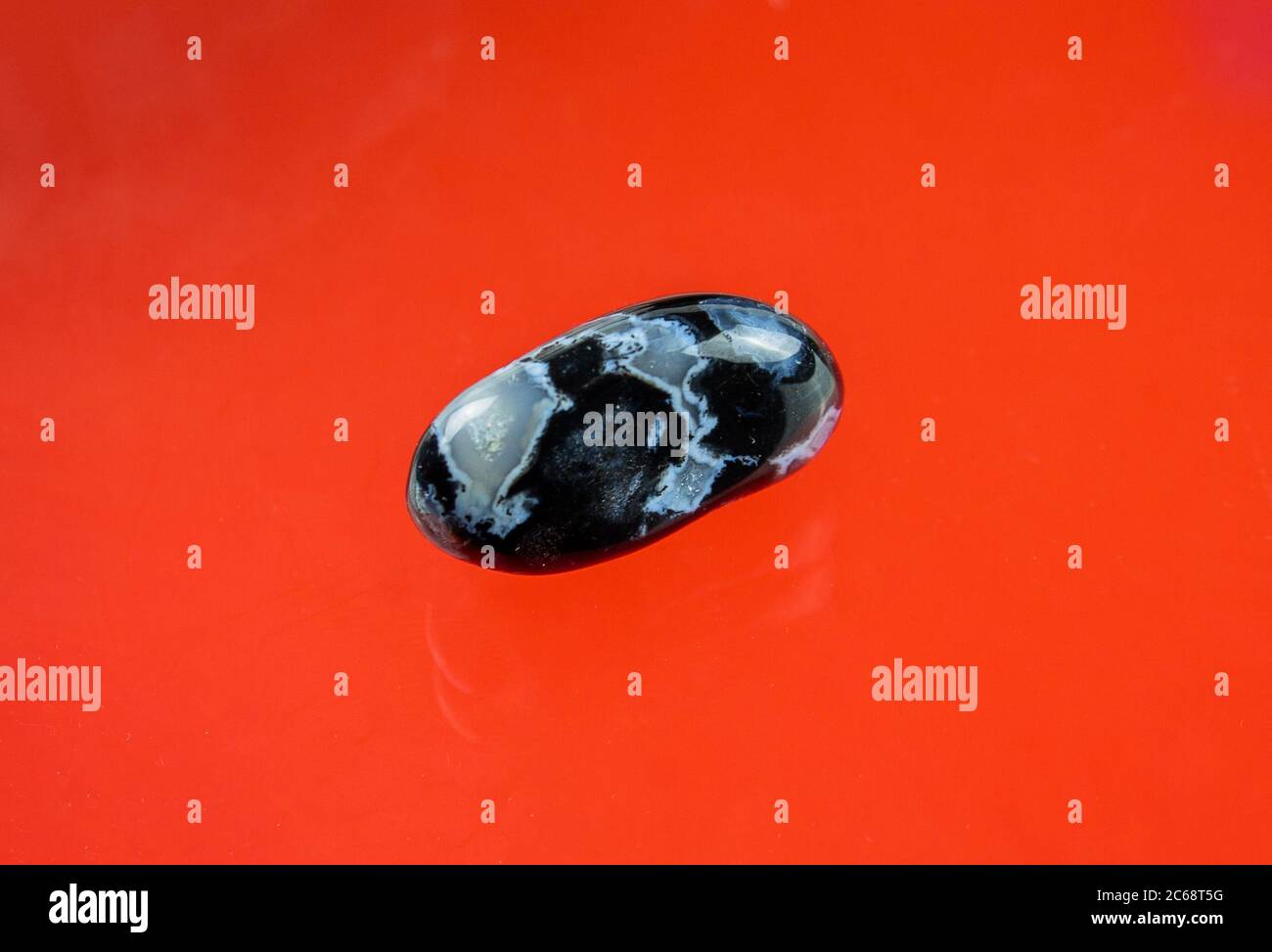 Black agate with transparent white quartz inclusions Stock Photo