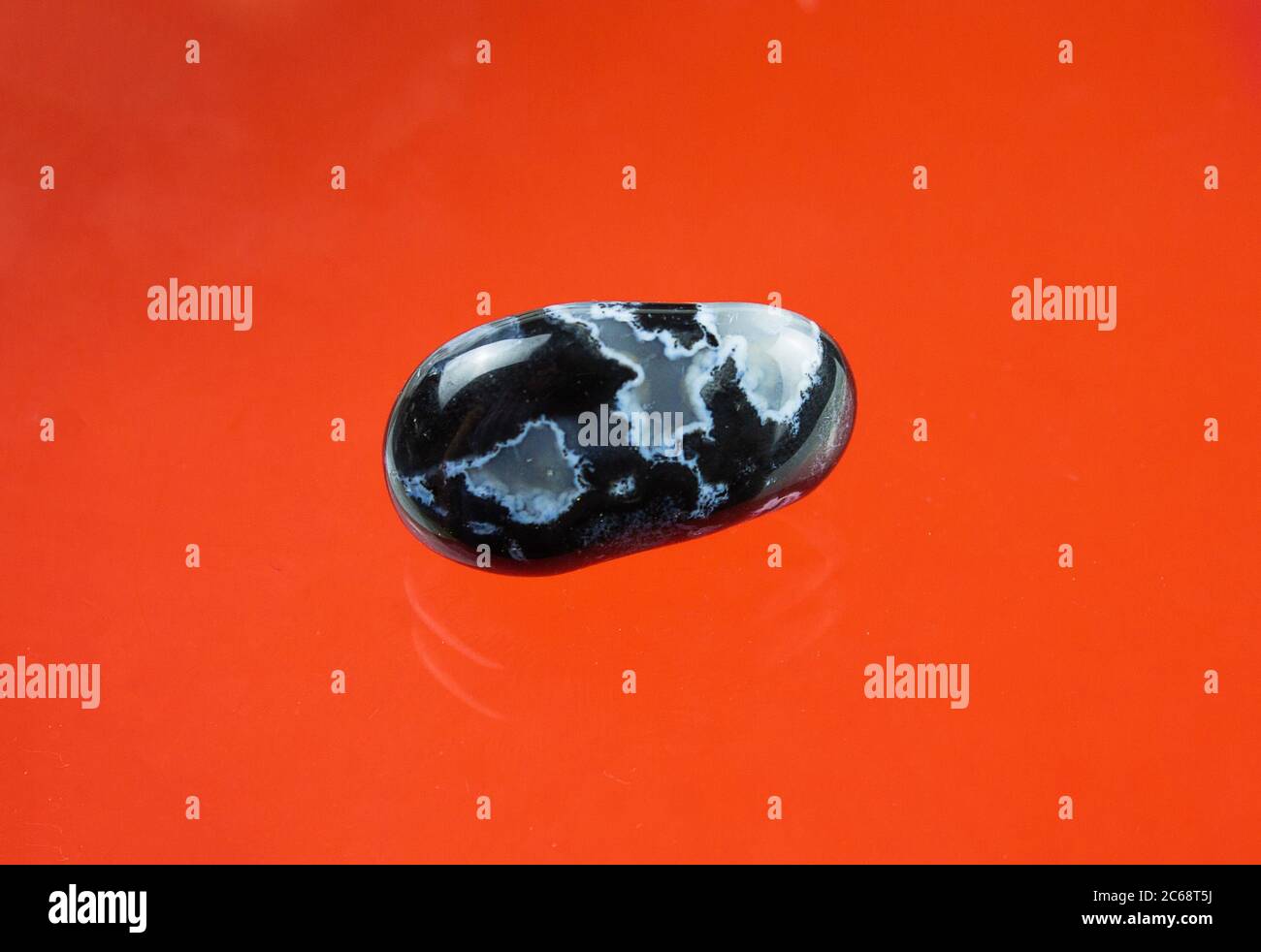 Black agate with transparent white quartz inclusions Stock Photo