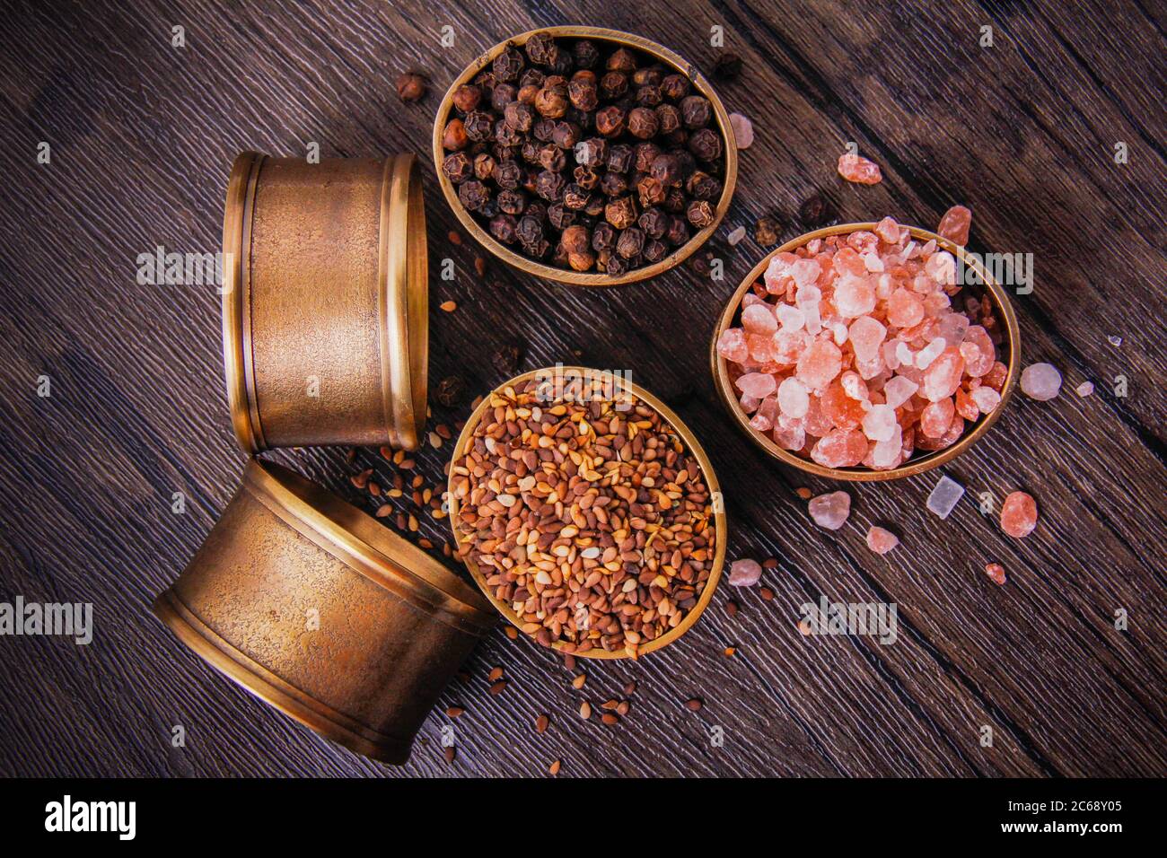 Sea salt, sesame and black pepper beans in tiny copper pots. Stock Photo