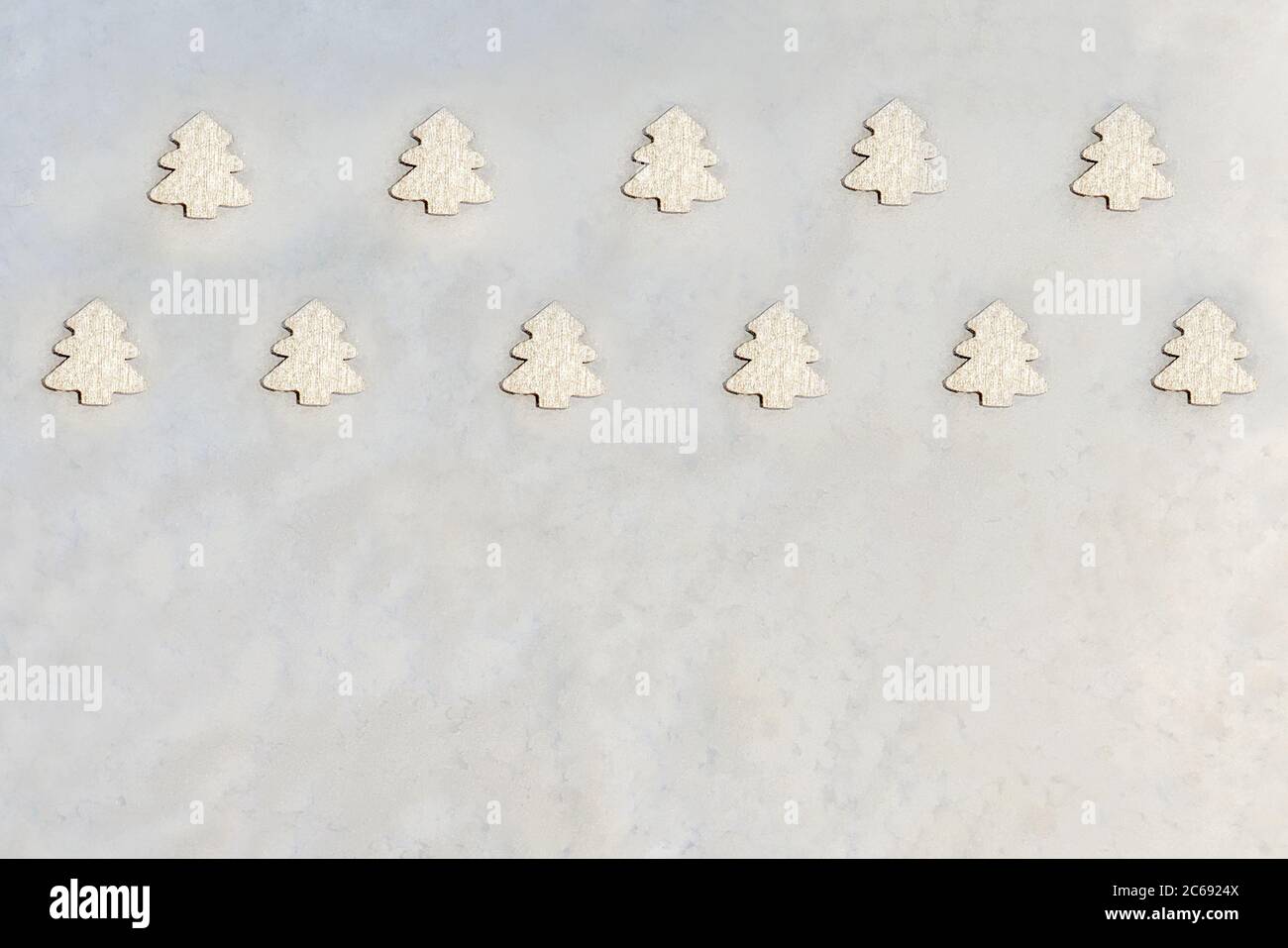 Creative layout made of Christmas silver trees on snow background. Flat lay. Minimalism. Space for text. Stock Photo