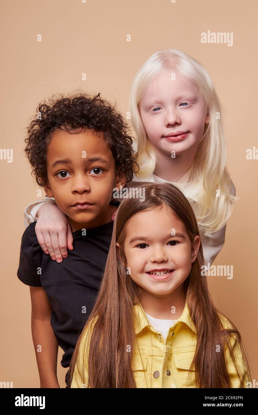 adorable kids of diverse nationalities and skin colors stand ...