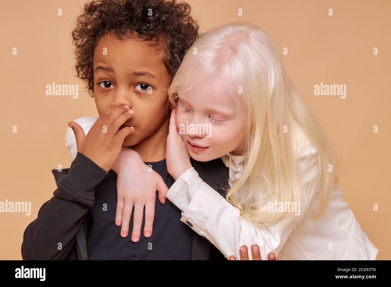Sensitive Albino Child Girl Hug Dark Skinned Boy Isolated In Studio Adorable Girl With White Hair Has Tender Feelings For The Boy Stock Photo Alamy