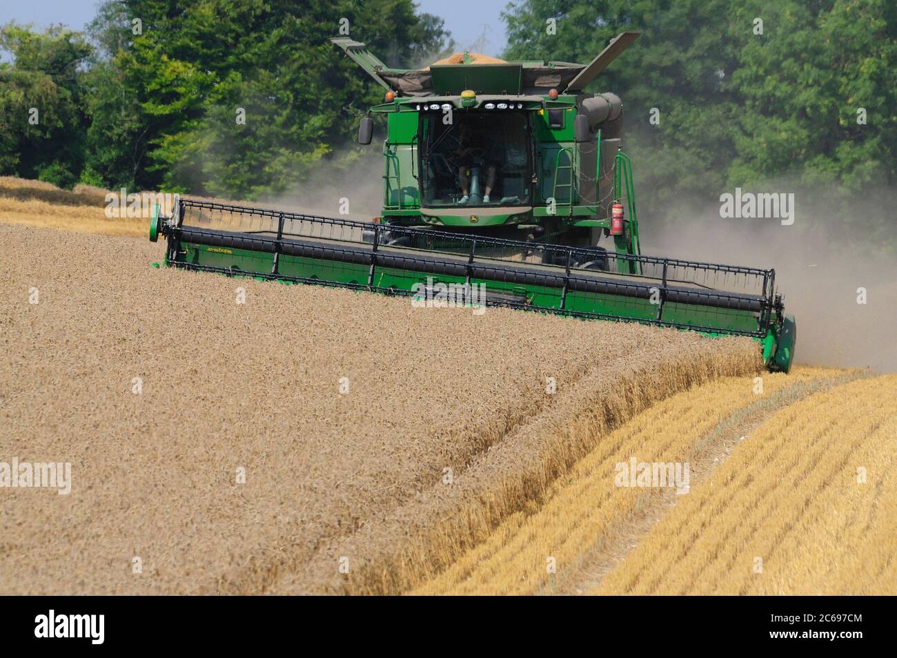 Combine harvester working near West Amesbury, Wiltshire, UK Stock Photo