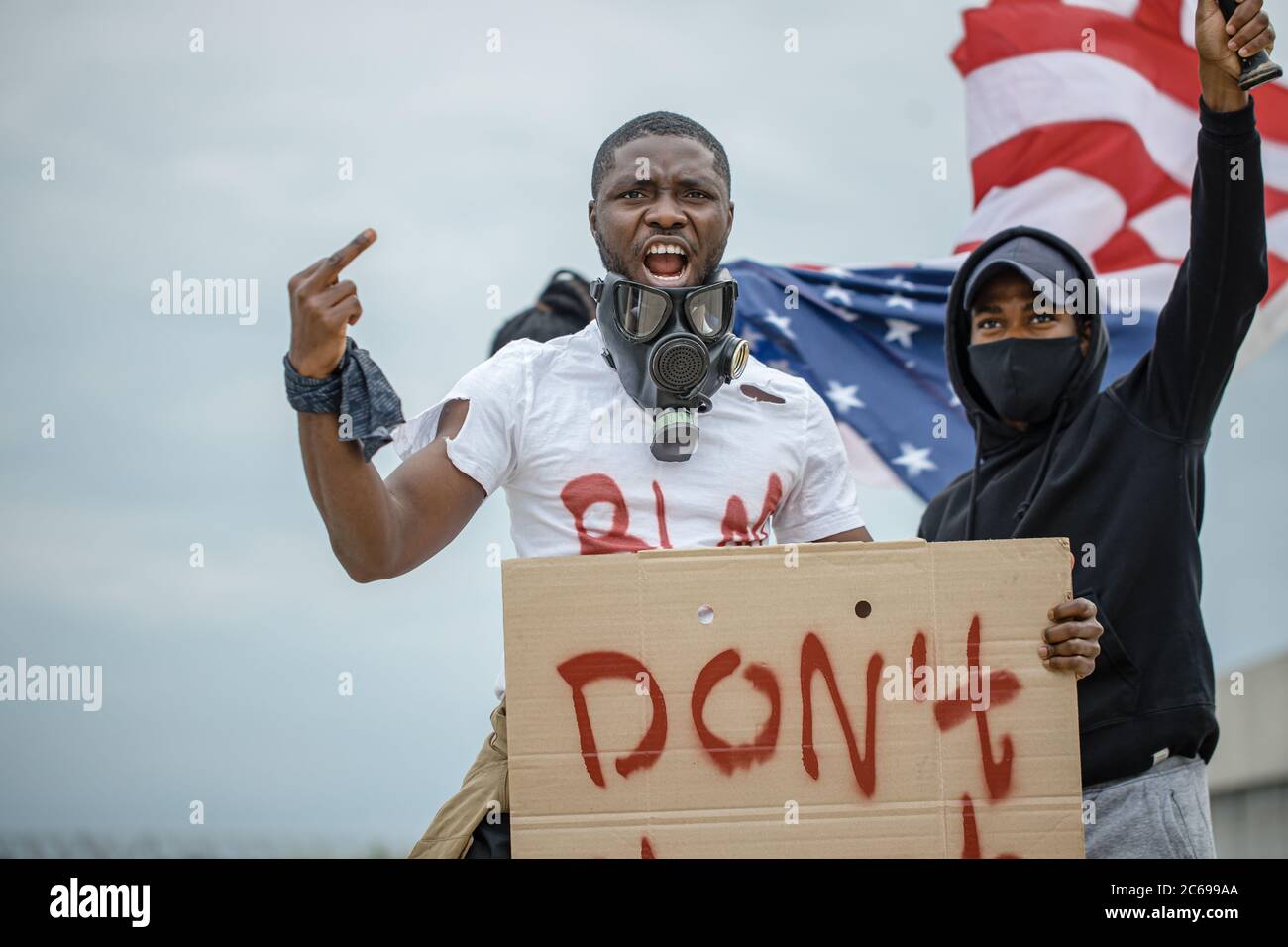 Demonstrators hold banners with the motto of the black civil rights movement 'Black Lives Matter', 'Don't shoot' to show their solidarity with African Stock Photo