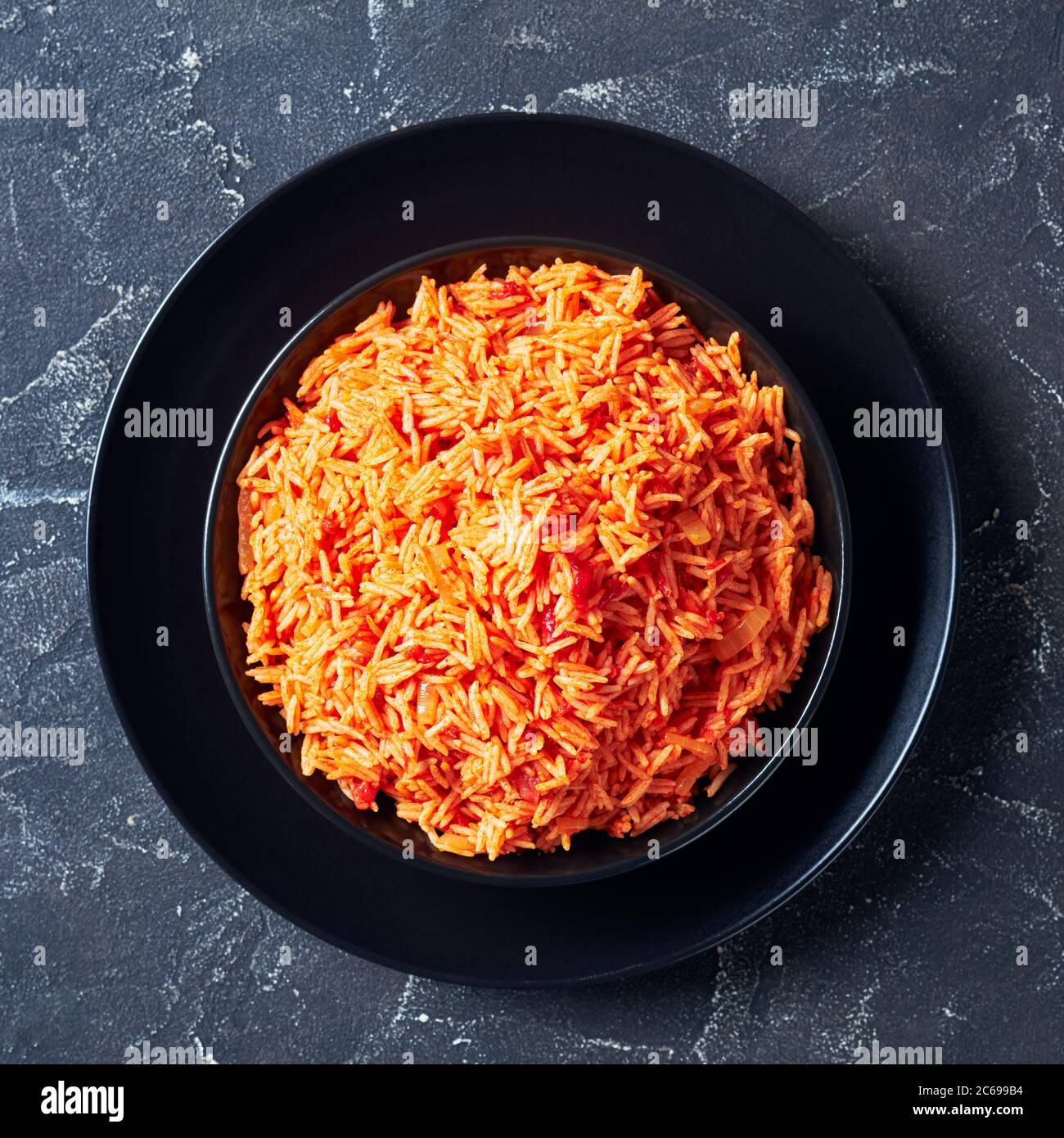Tomato onion rice pilaf, Tamatar Biryani on a black plate on a dark