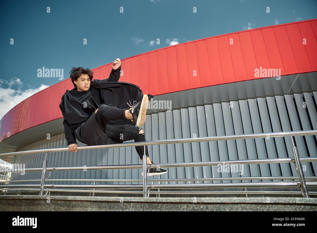 Young man jumping over railing hires stock photography and images Alamy