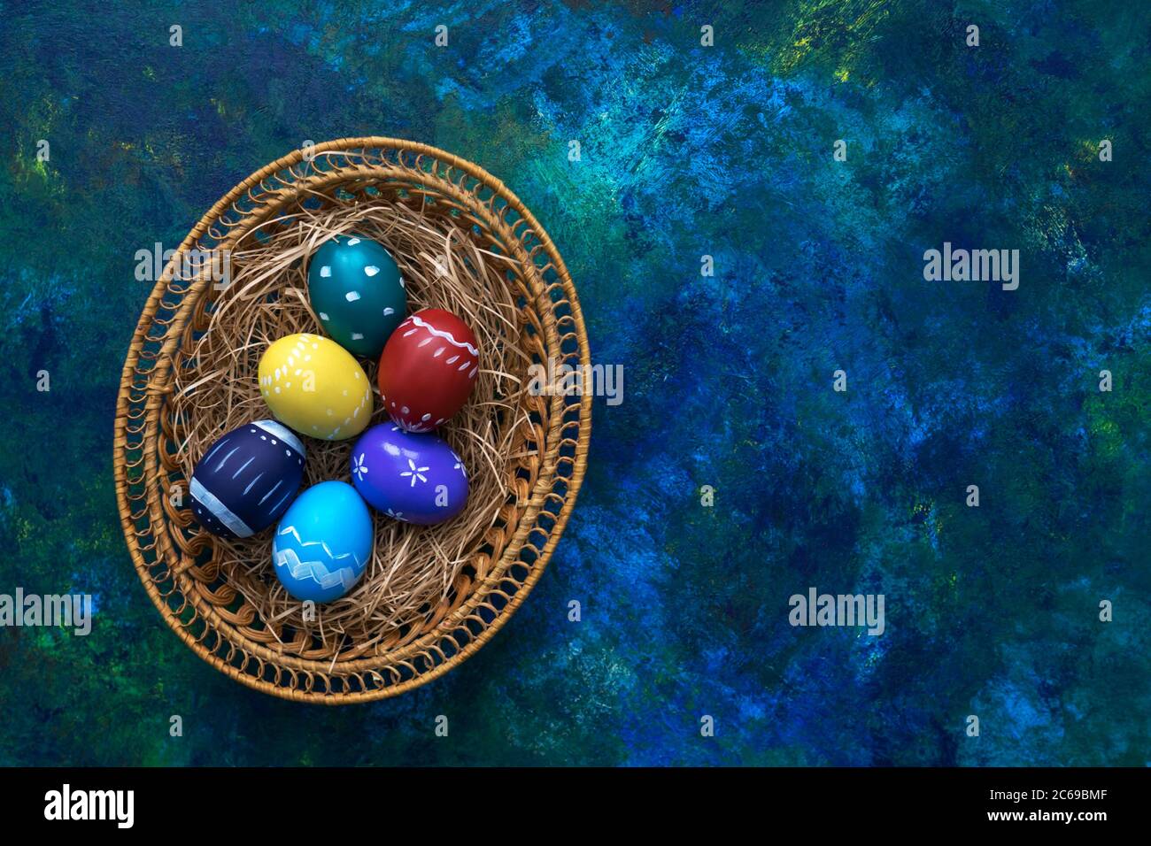 Multi-colored easter paint eggs in pottle on multi-colored background. Festive easter concept. Copy space. Stock Photo