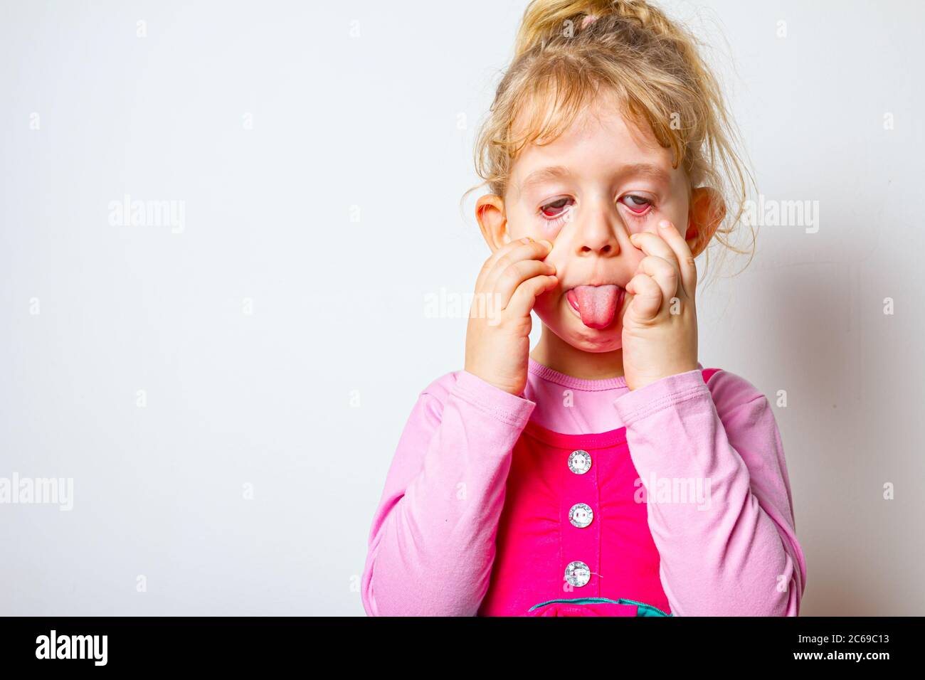 Portrait of sweet little girl as she is sticking her