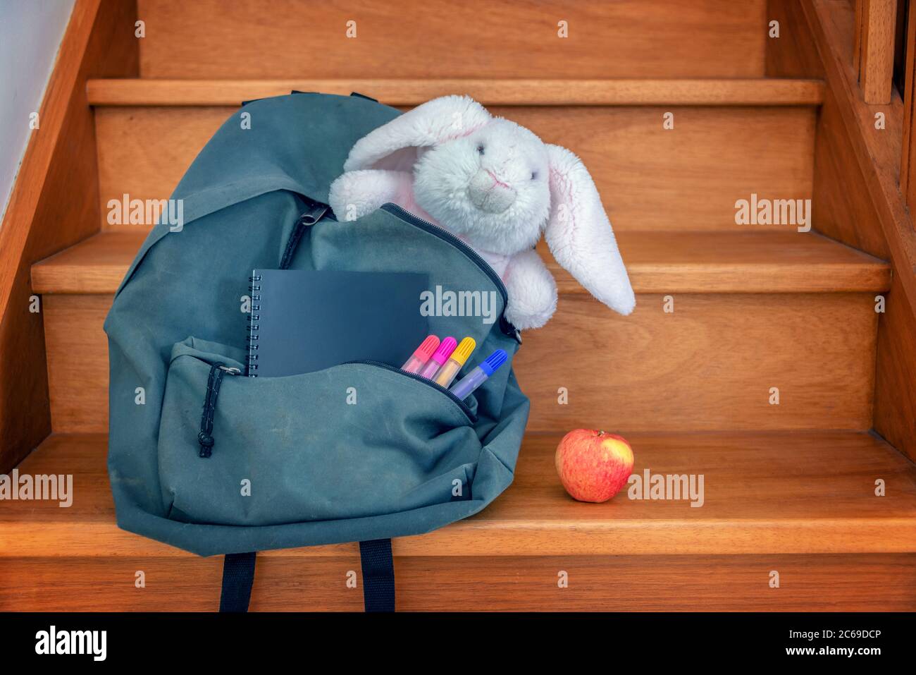 School bag with cuddly toy, supplies and lunch Stock Photo