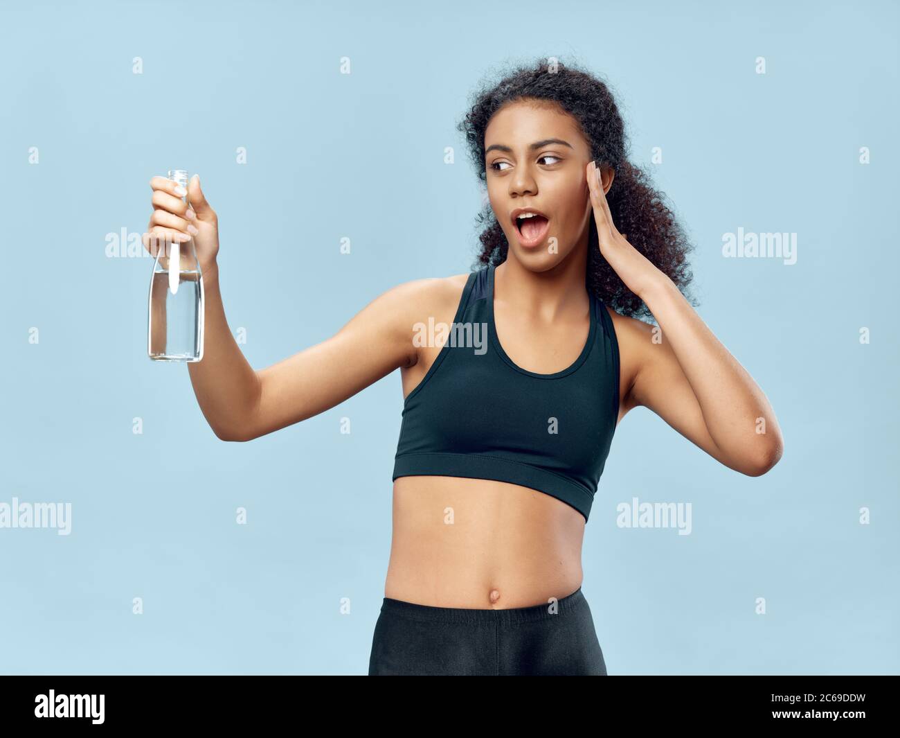 Premium Photo  Tired after workout. attractive young woman in white bra  and panties holding bottle with water and smiling while standing isolated  on white