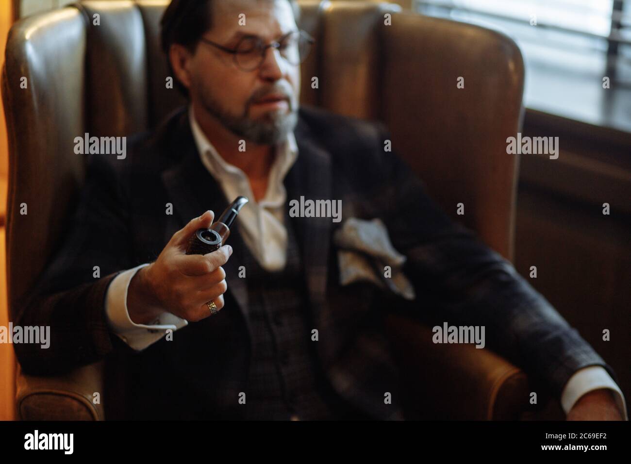 Pensive mature bearded businessman in 