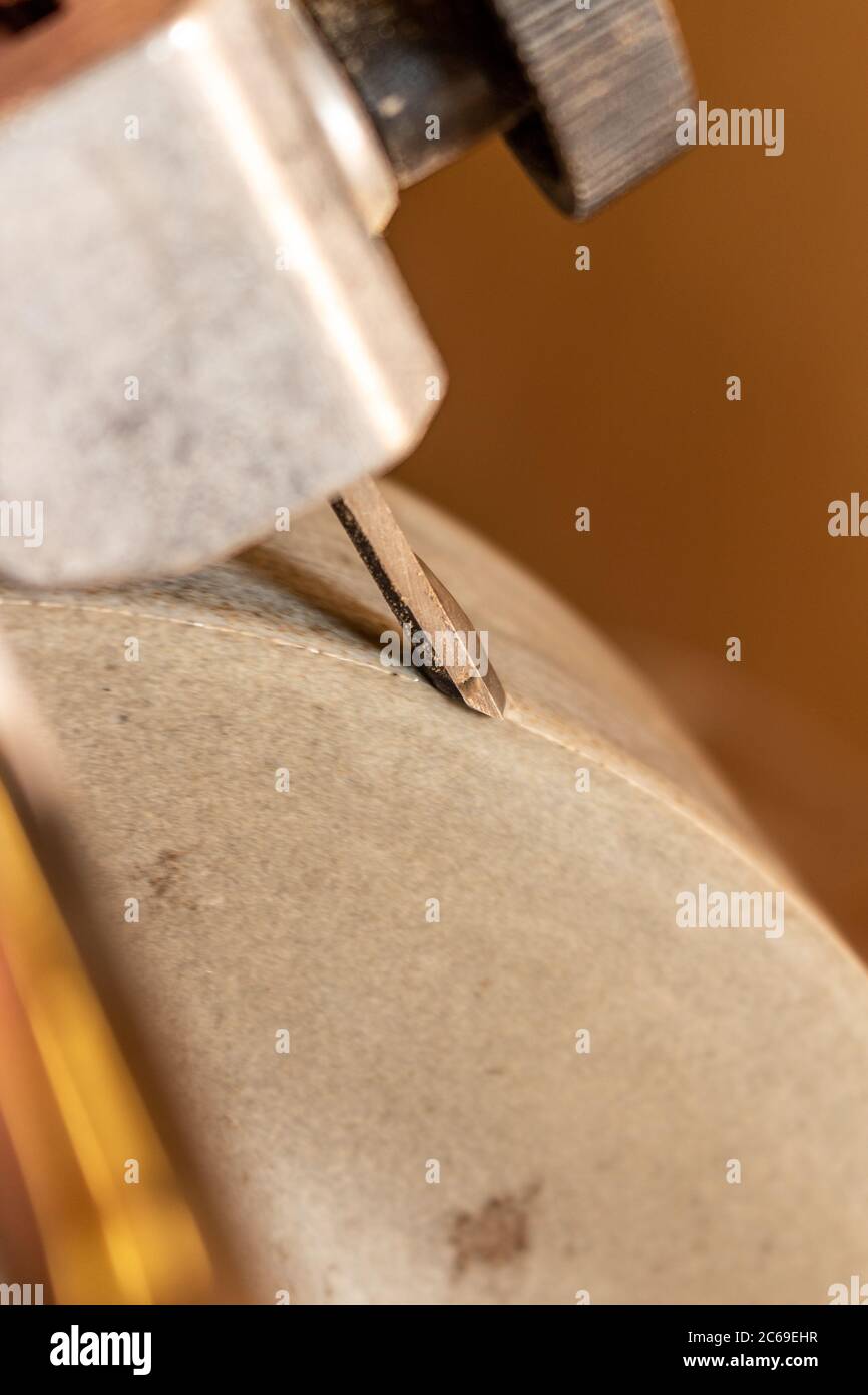 Sharpening a chisel on a wet stone grinder Stock Photo Alamy