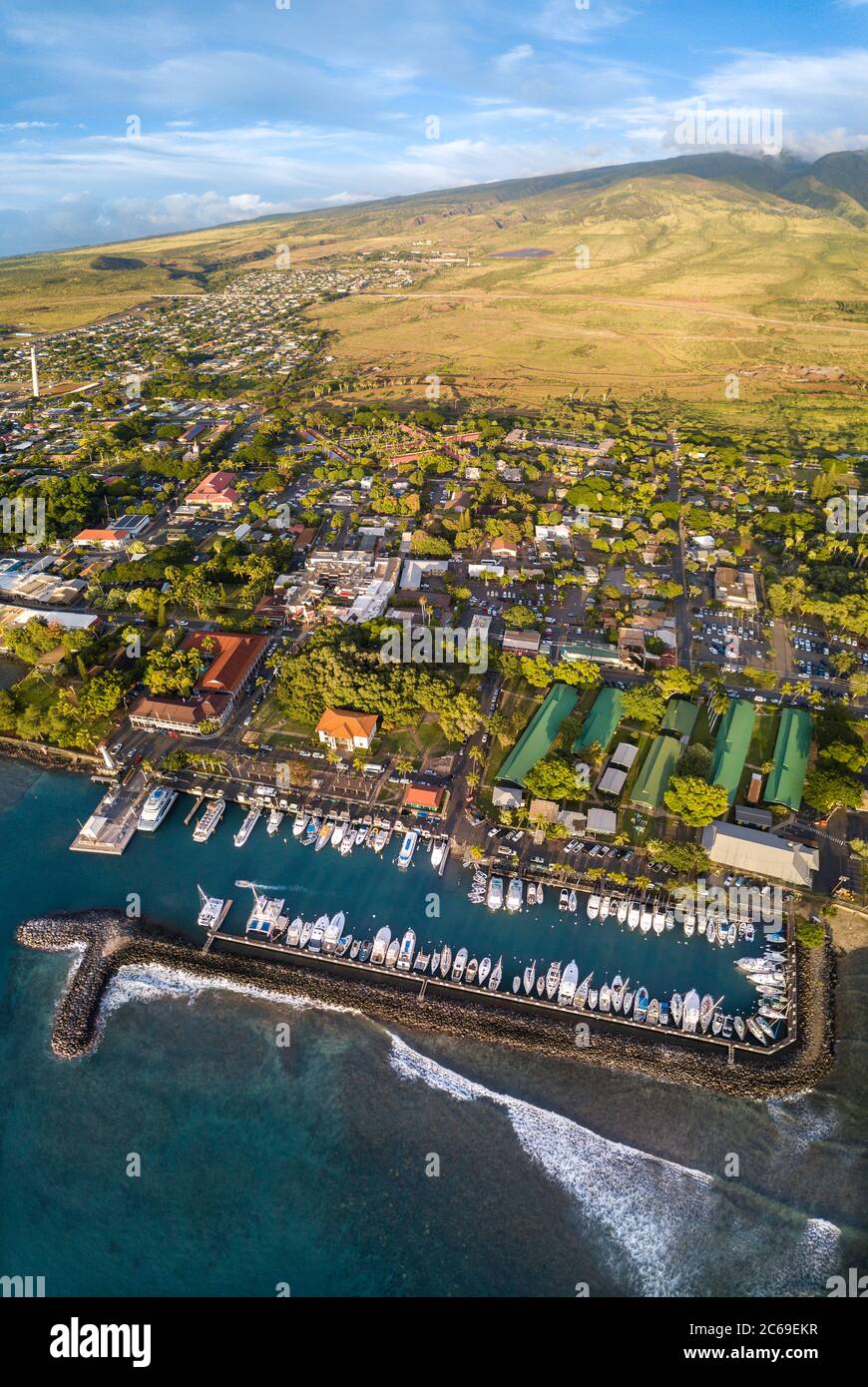 An aerial view of Lahaina harbor and town including the Pioneer Inn and West Maui Mountains