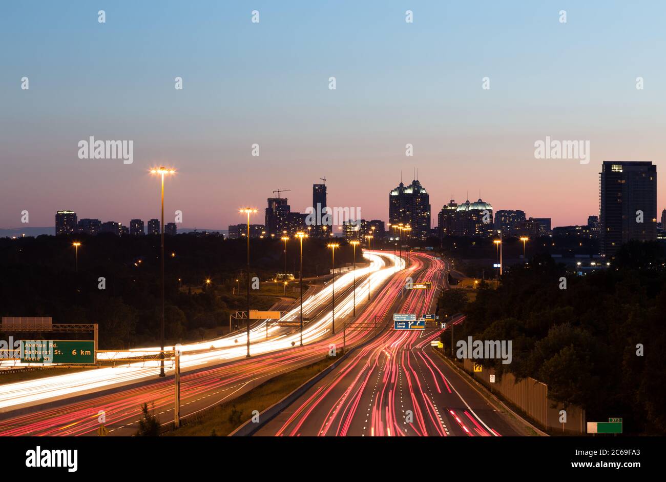 Light trails on a Motorway at Dusk Stock Photo