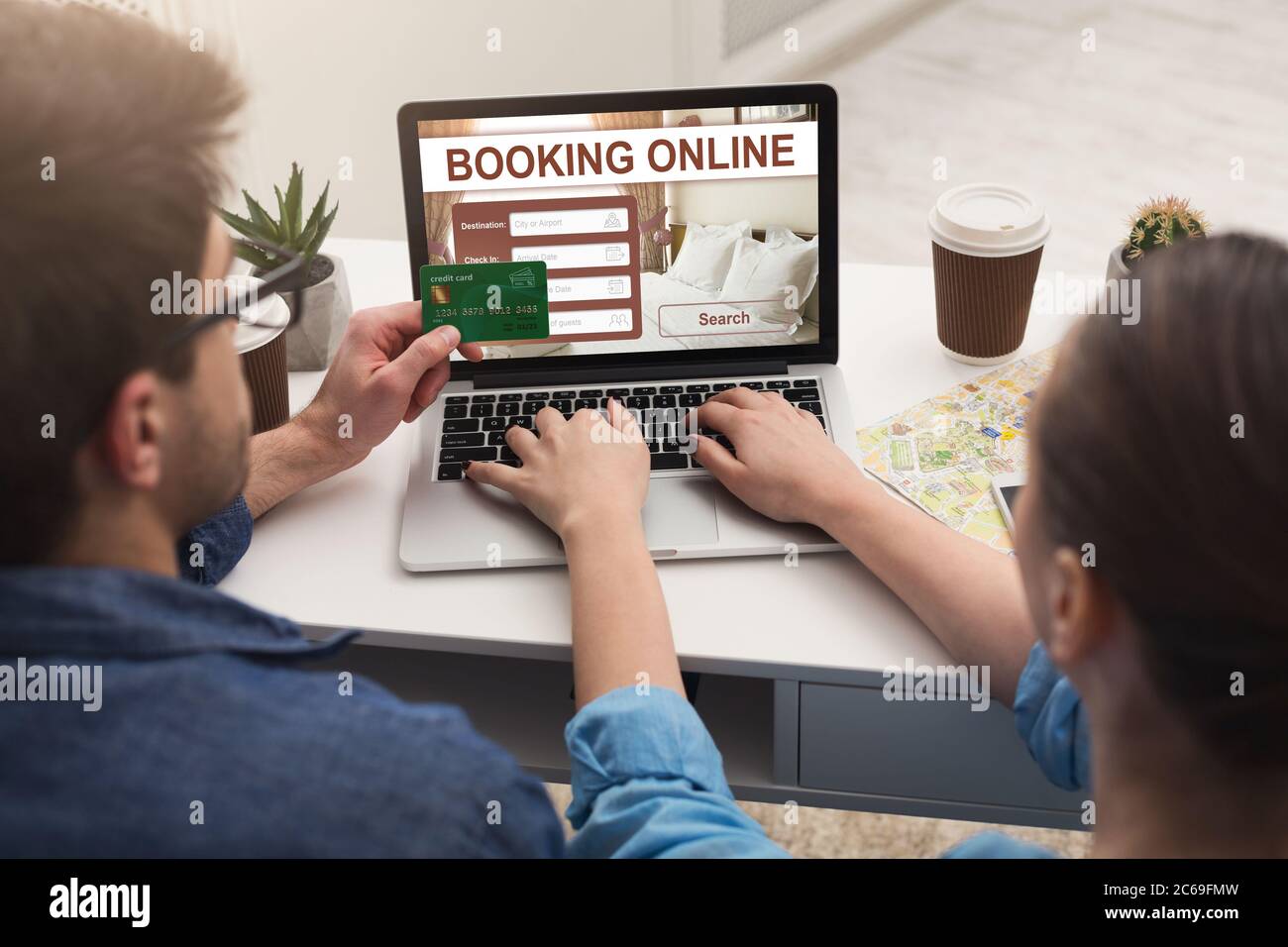 Couple making hotel reservation online, using laptop Stock Photo