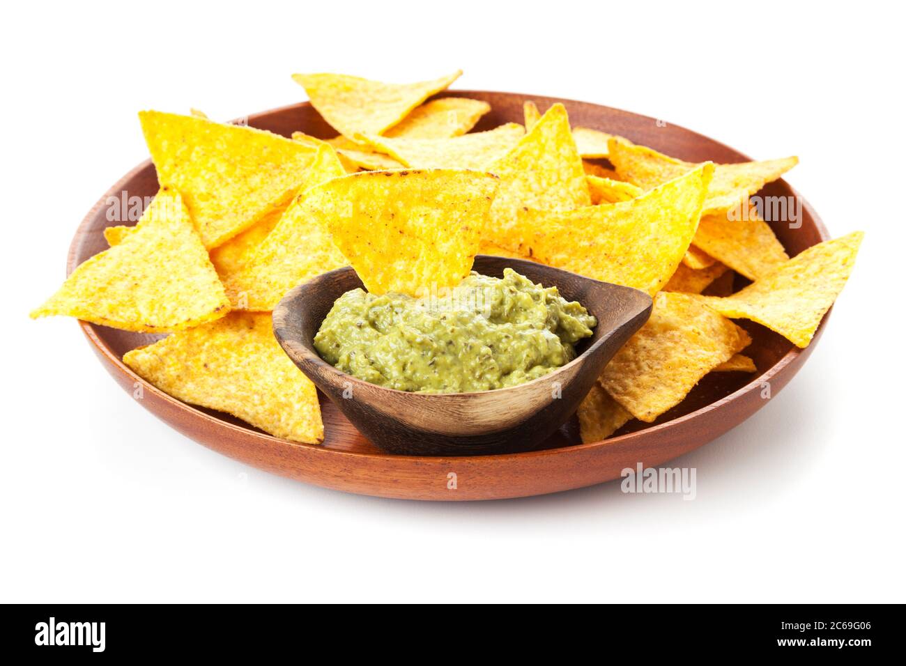 Wooden plate with tortilla chips and Guacamole in bowl isolated on white background Stock Photo