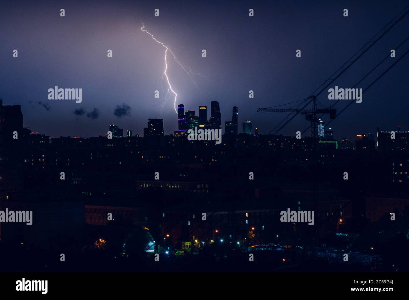 A lightning flashes during a thunderstorm over Moscow city business centre. Stock Photo