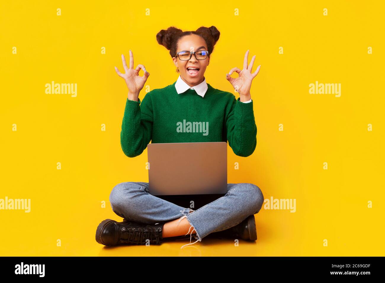 Happy young black woman showing ok gesture Stock Photo - Alamy