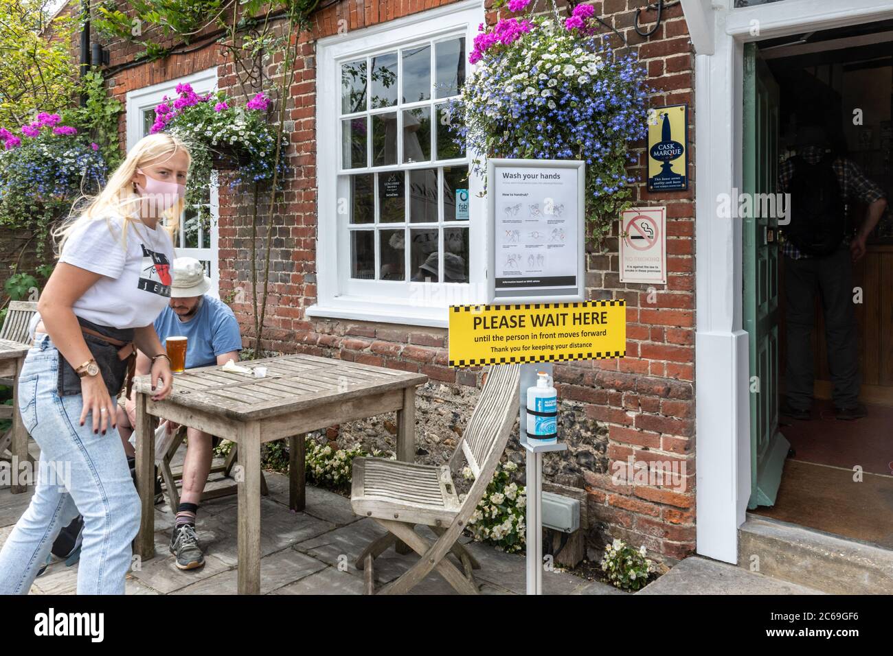 Pubs have reopened in England after coronavirus covid-19 restrictions have eased, 7 July 2020, UK. Pub with hand wash station and safety signs outside Stock Photo