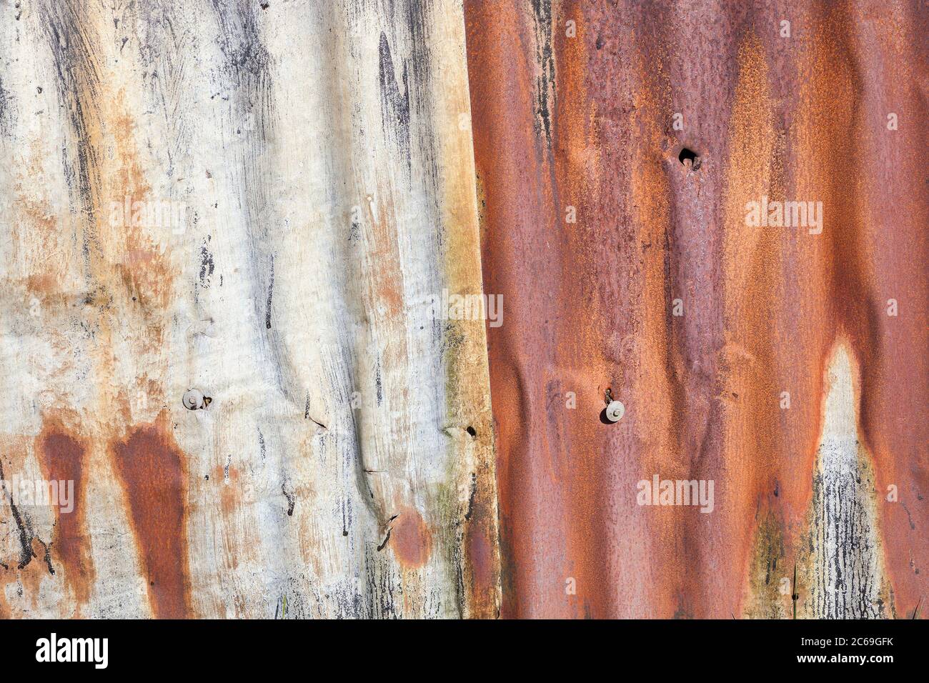 Distressed old corrugated rust covered iron fence texture background Stock Photo
