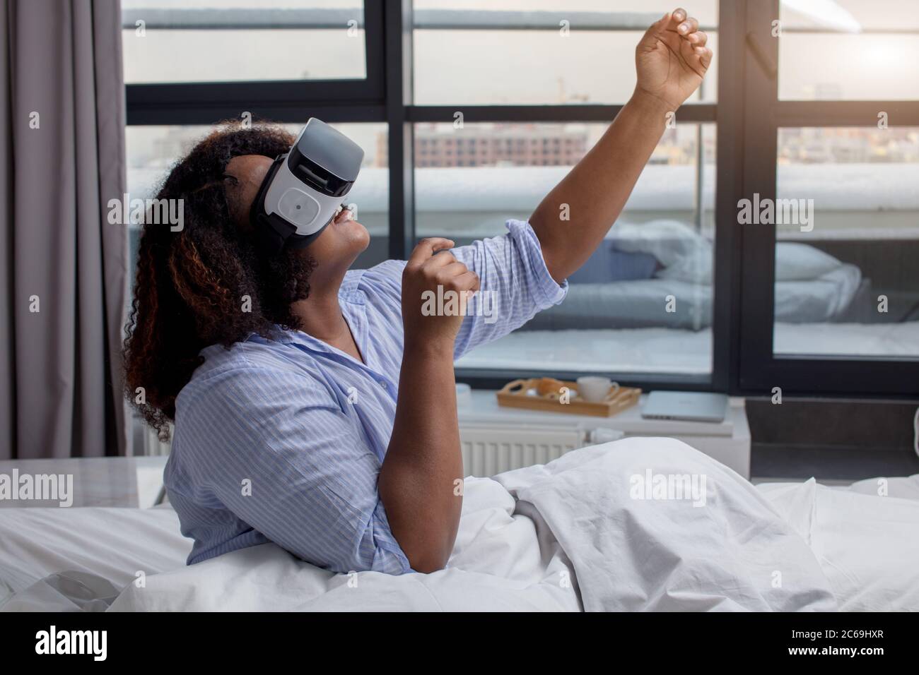 funny girl dancing while using a virtual gogglles, side view photo